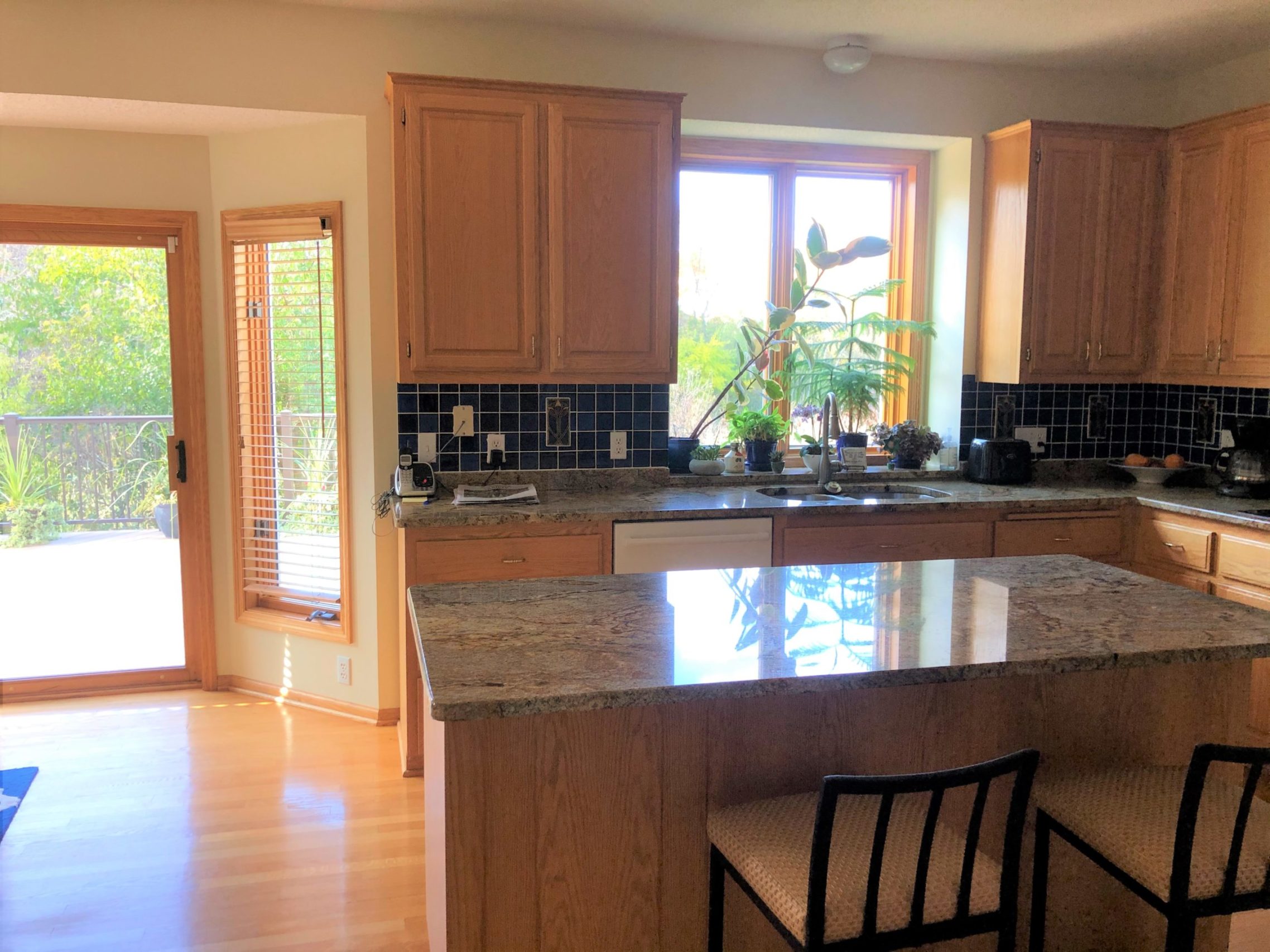 A kitchen remodel with a granite counter top and stainless steel appliances.