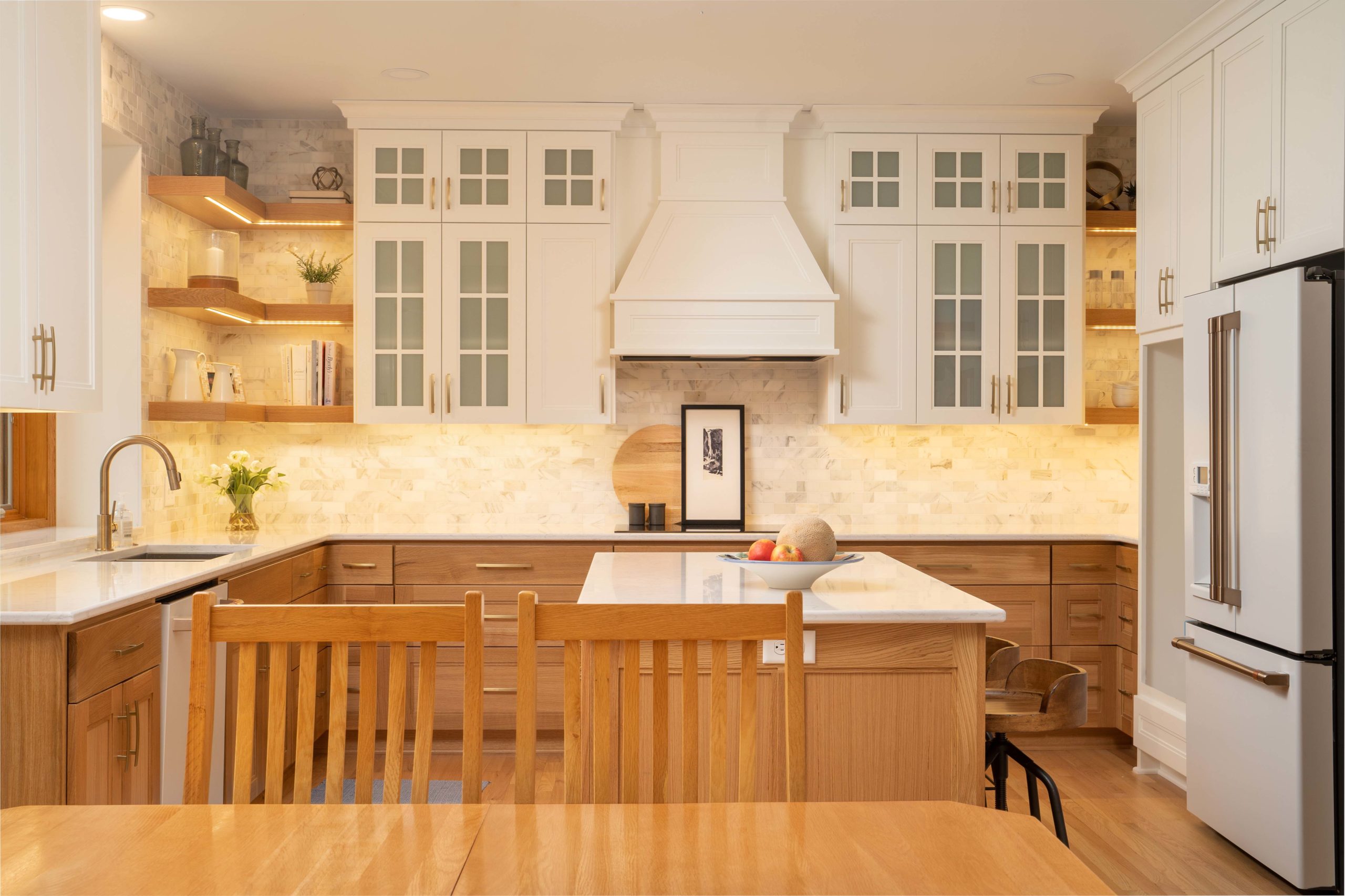 A kitchen remodel with white cabinets and wood counter tops.