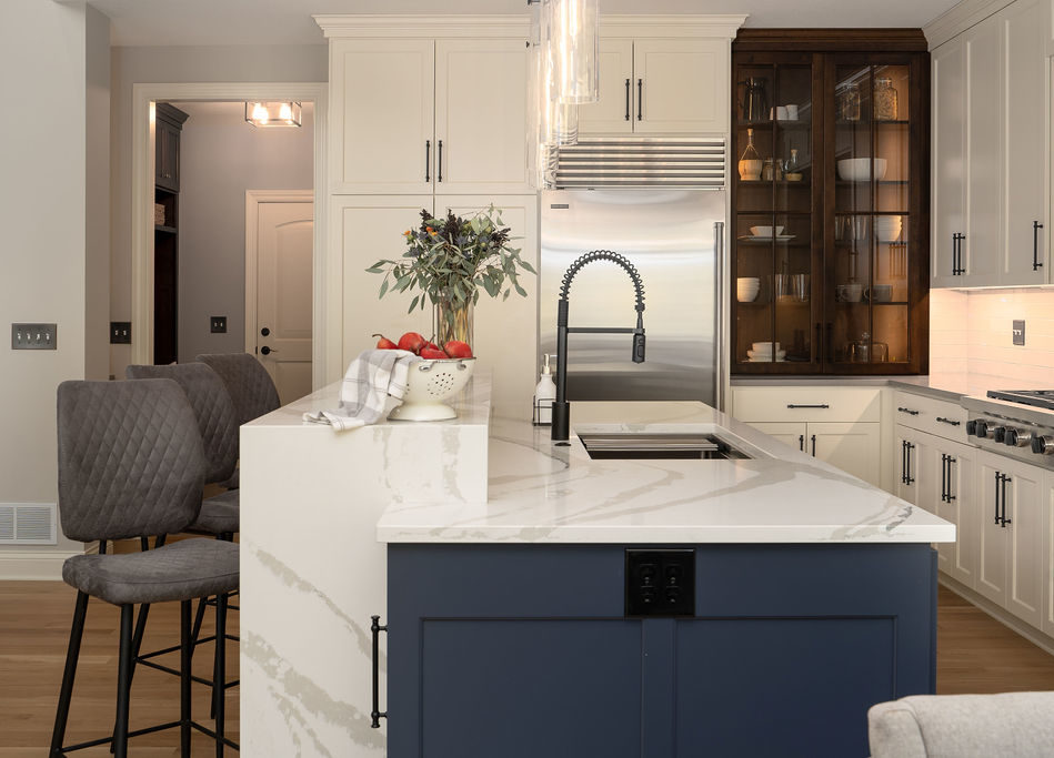 An Edina remodel with a white kitchen and a blue island.