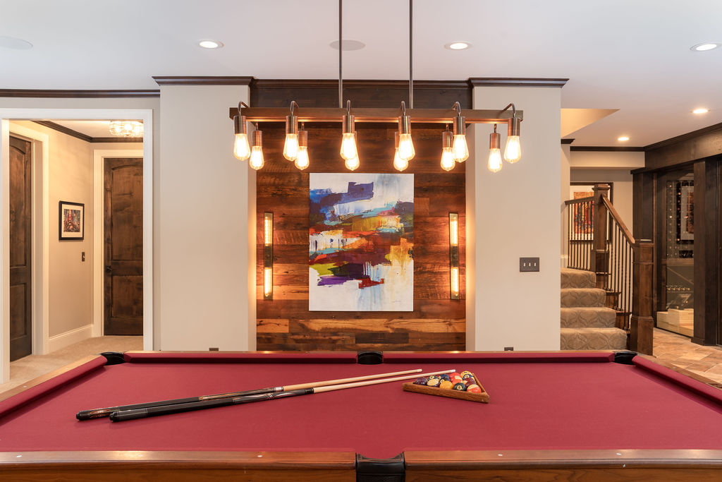 An Edina remodel featuring a pool table in a cozy room with a fireplace.