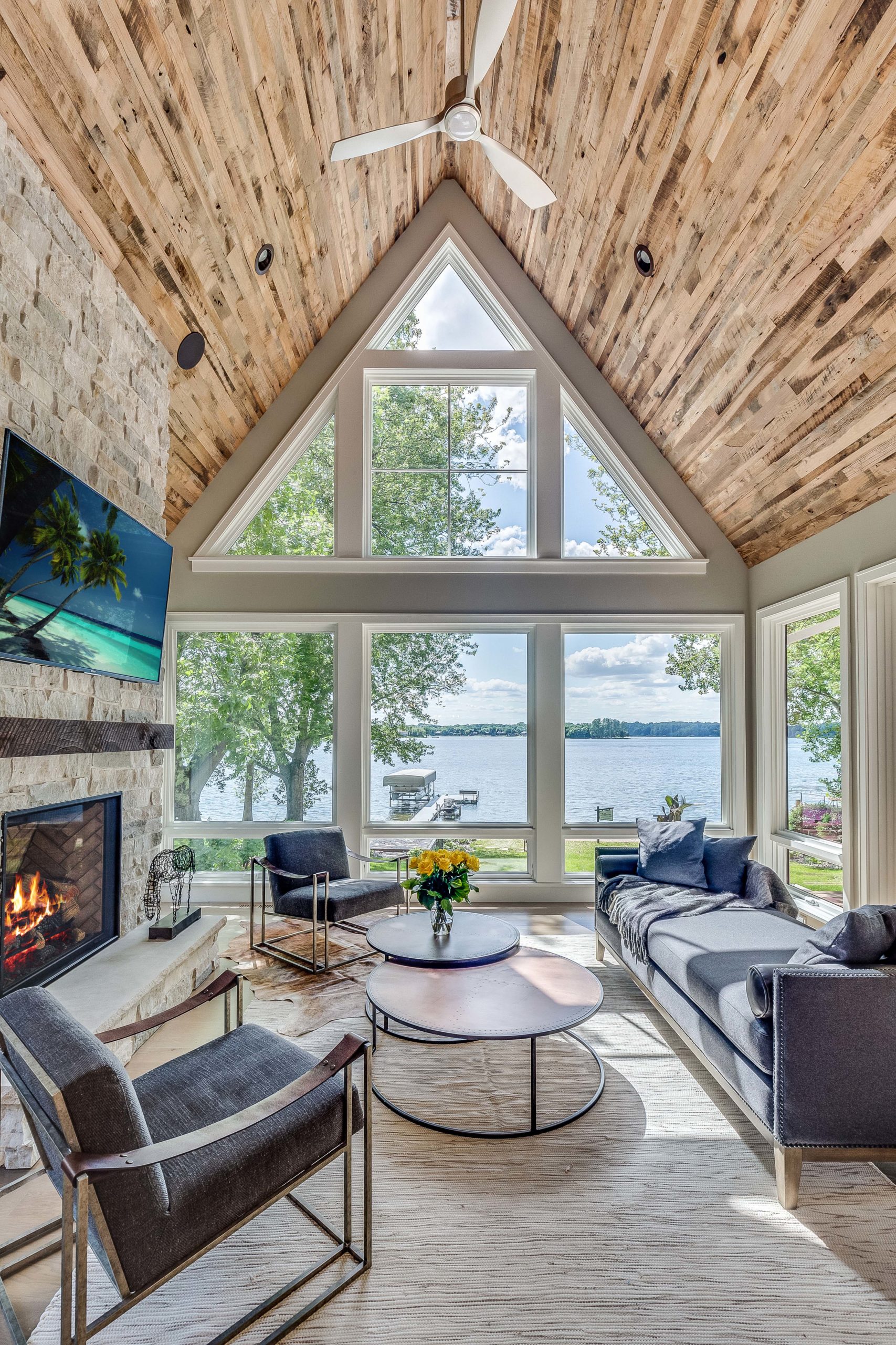 A large living room with a fireplace and a view of the lake.