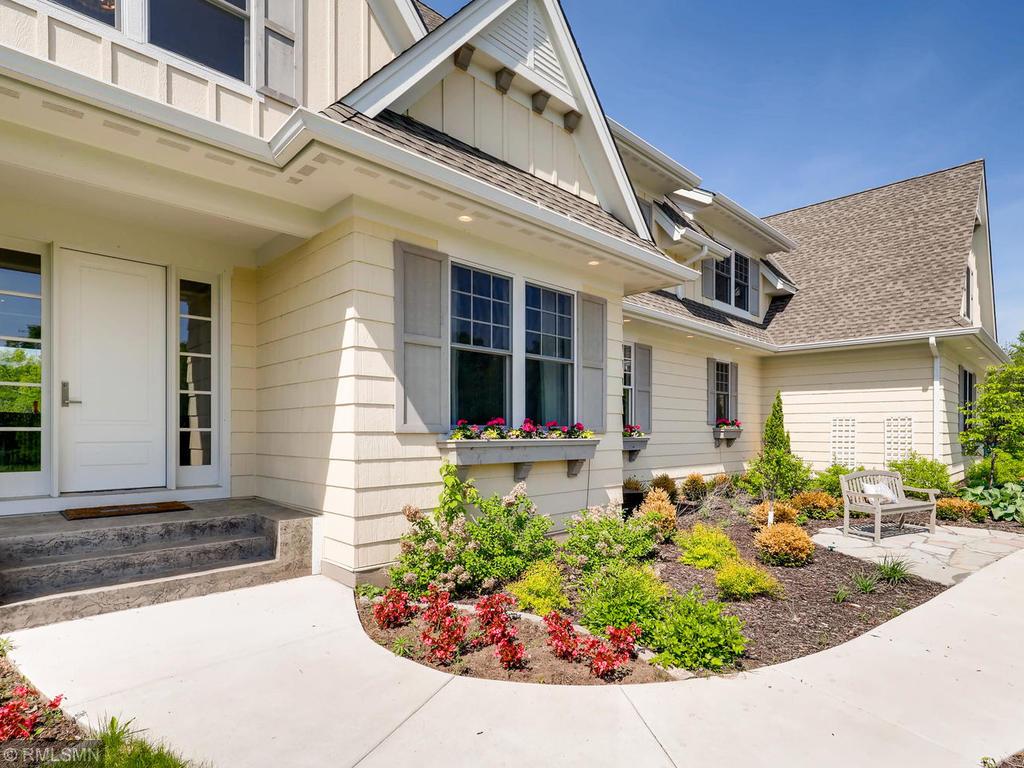 Explore home exterior design ideas featuring a front porch and expertly styled landscaping.