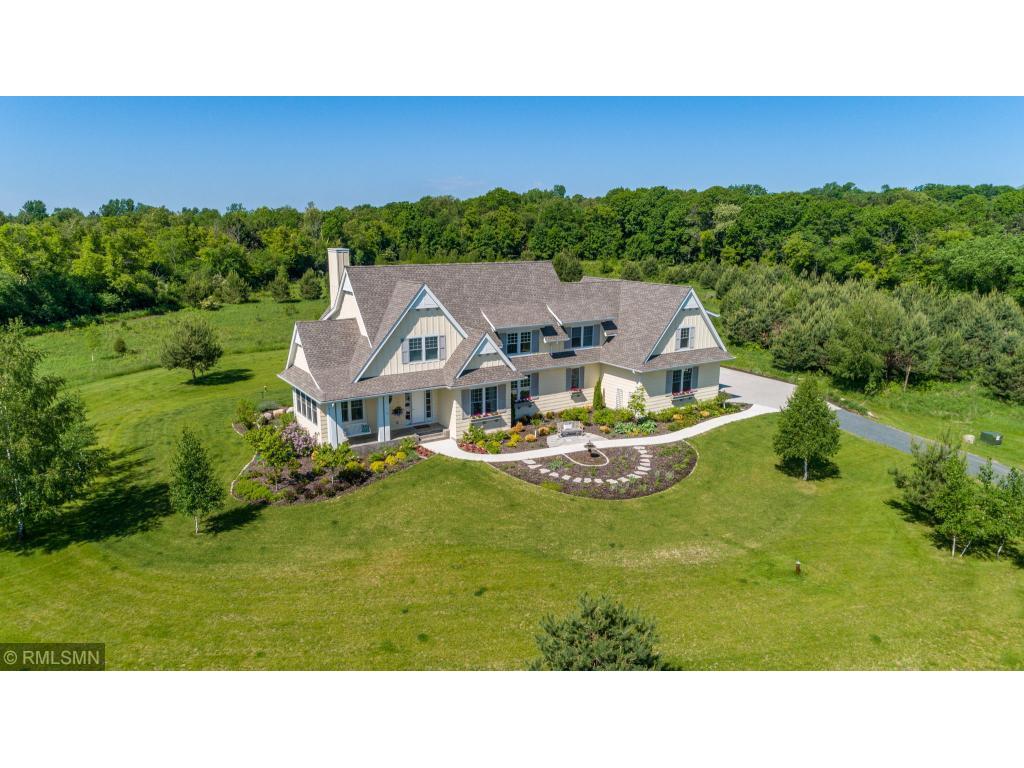 Aerial country view of cream 2-level Highmark home with white trim.