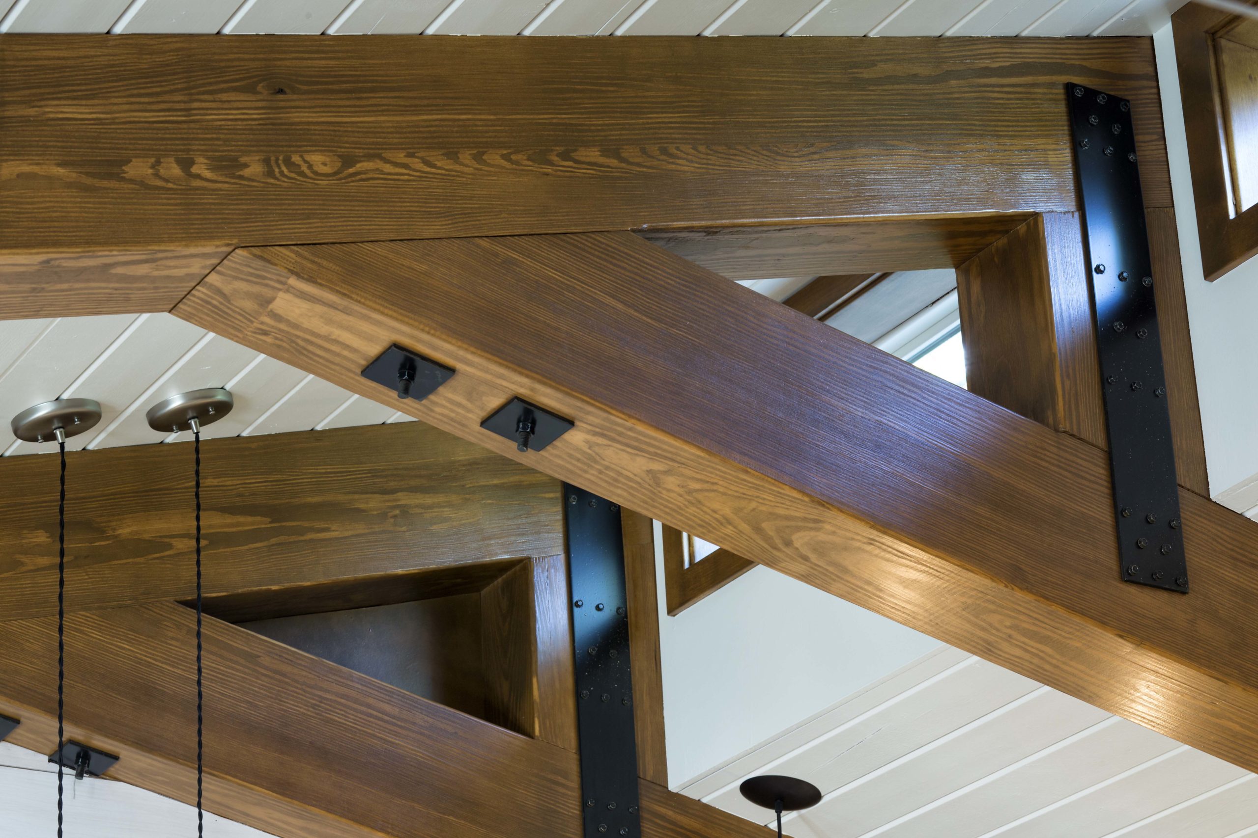A wooden beam in the ceiling of a room.