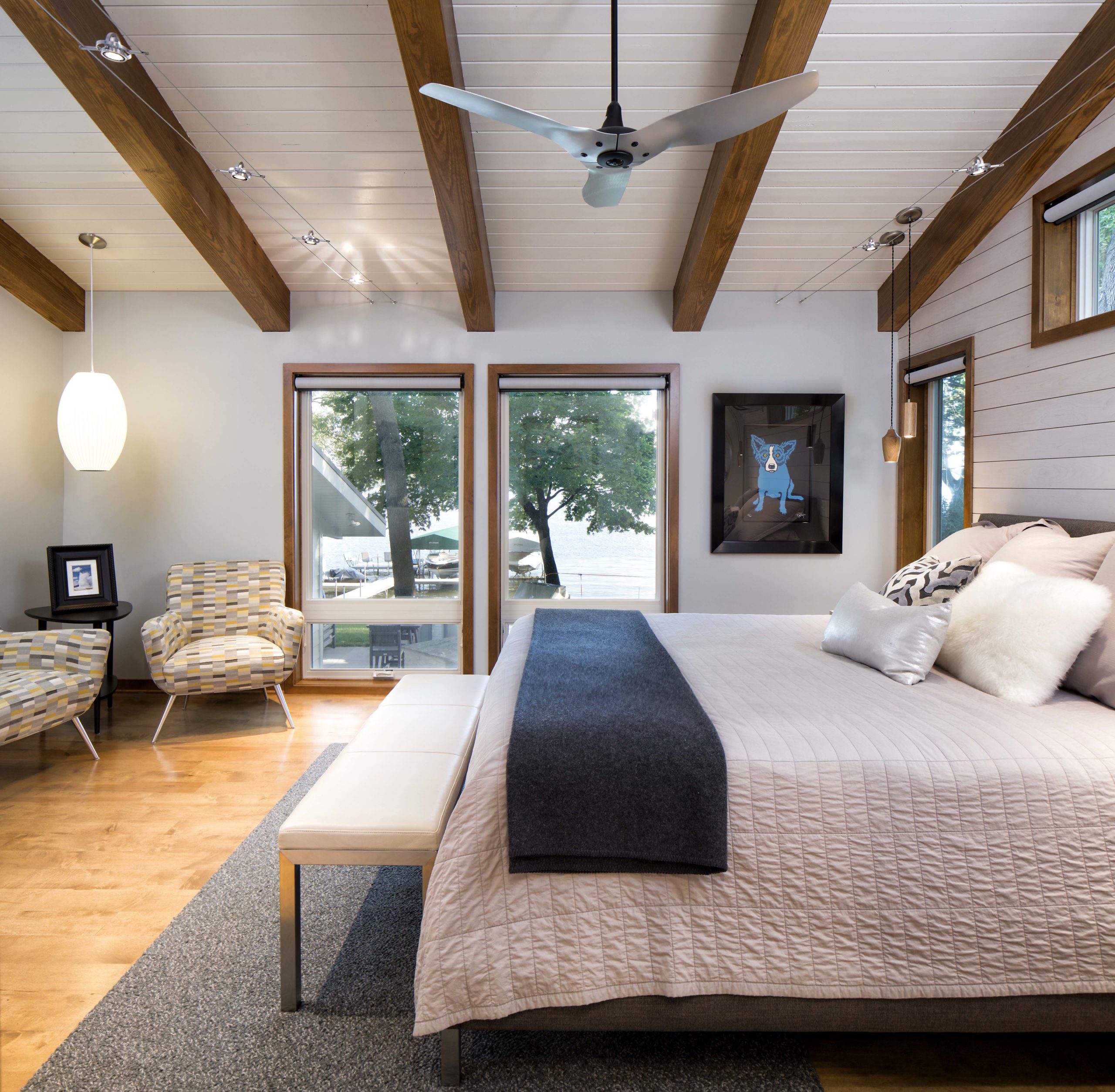 A bedroom with wood ceilings and a bed.