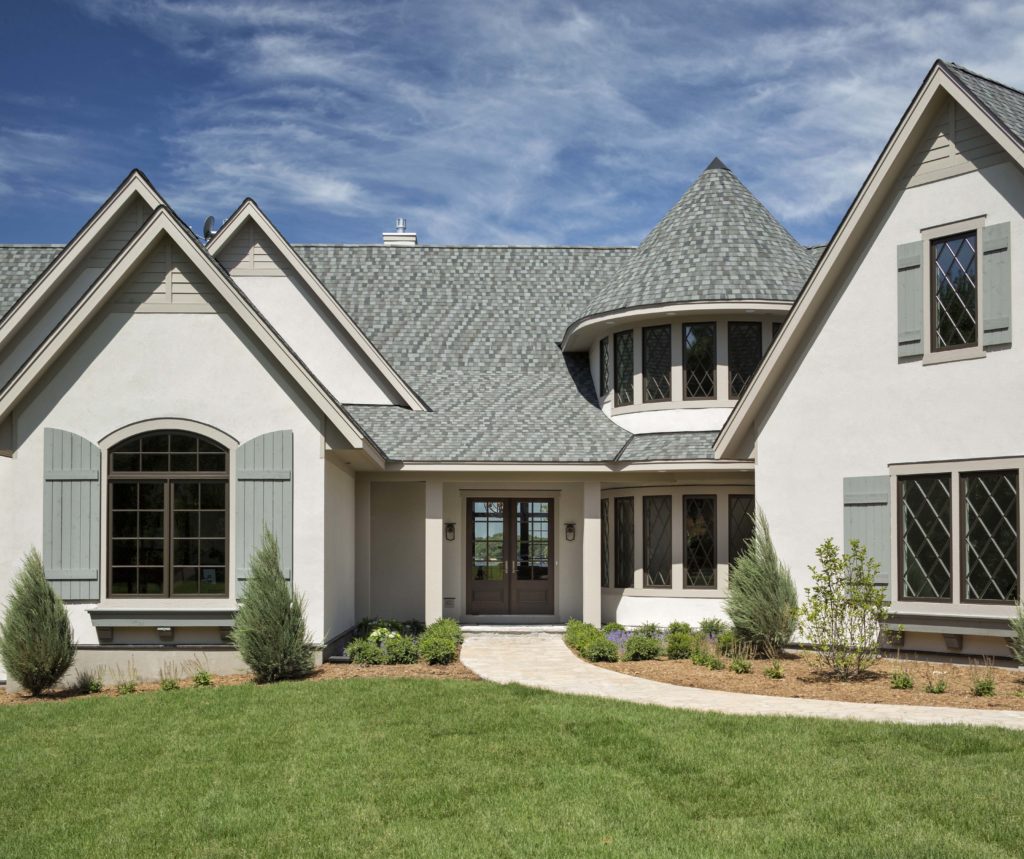 A white and gray home with a large front porch.