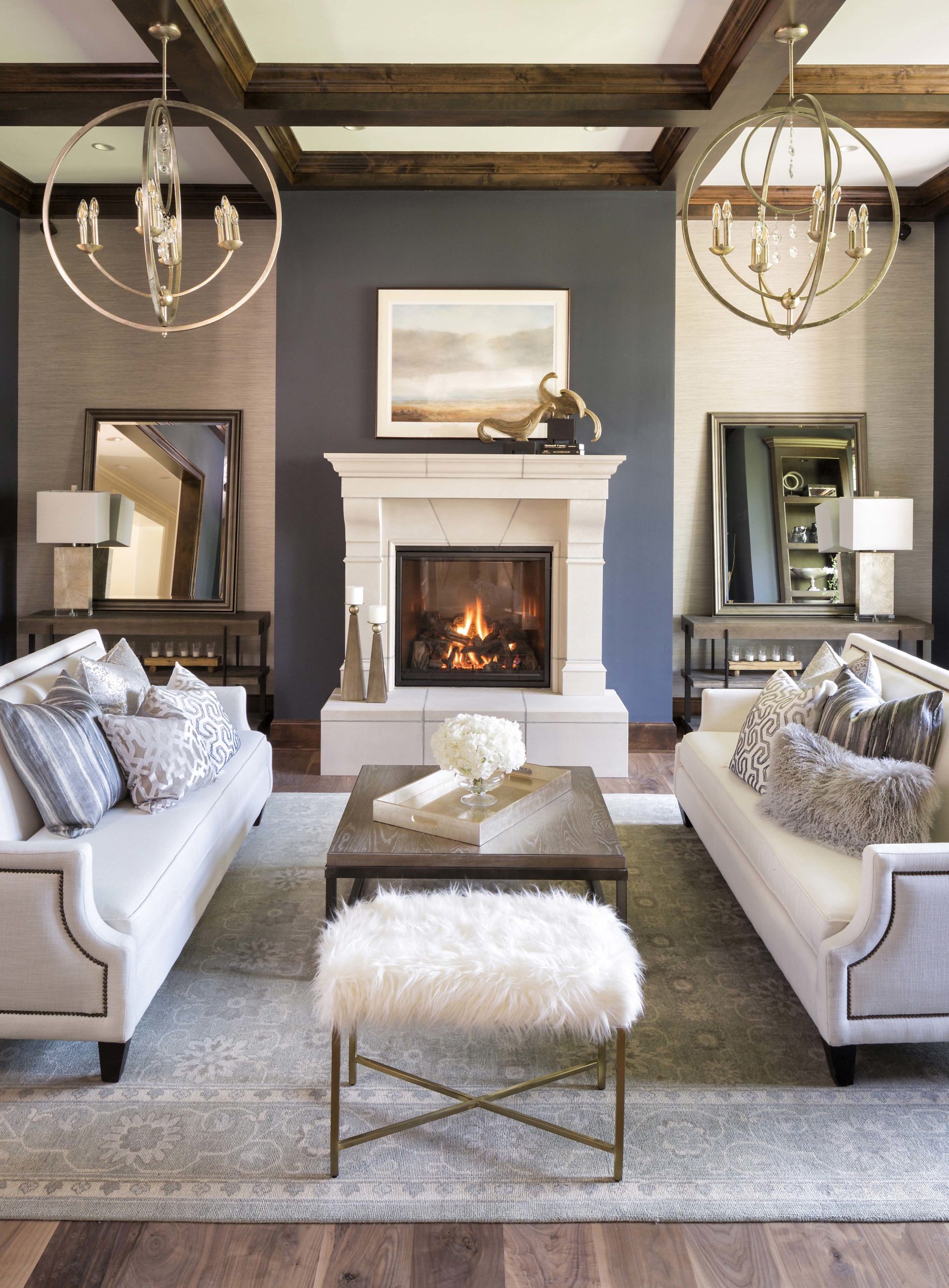A living room with white couches and a fireplace.