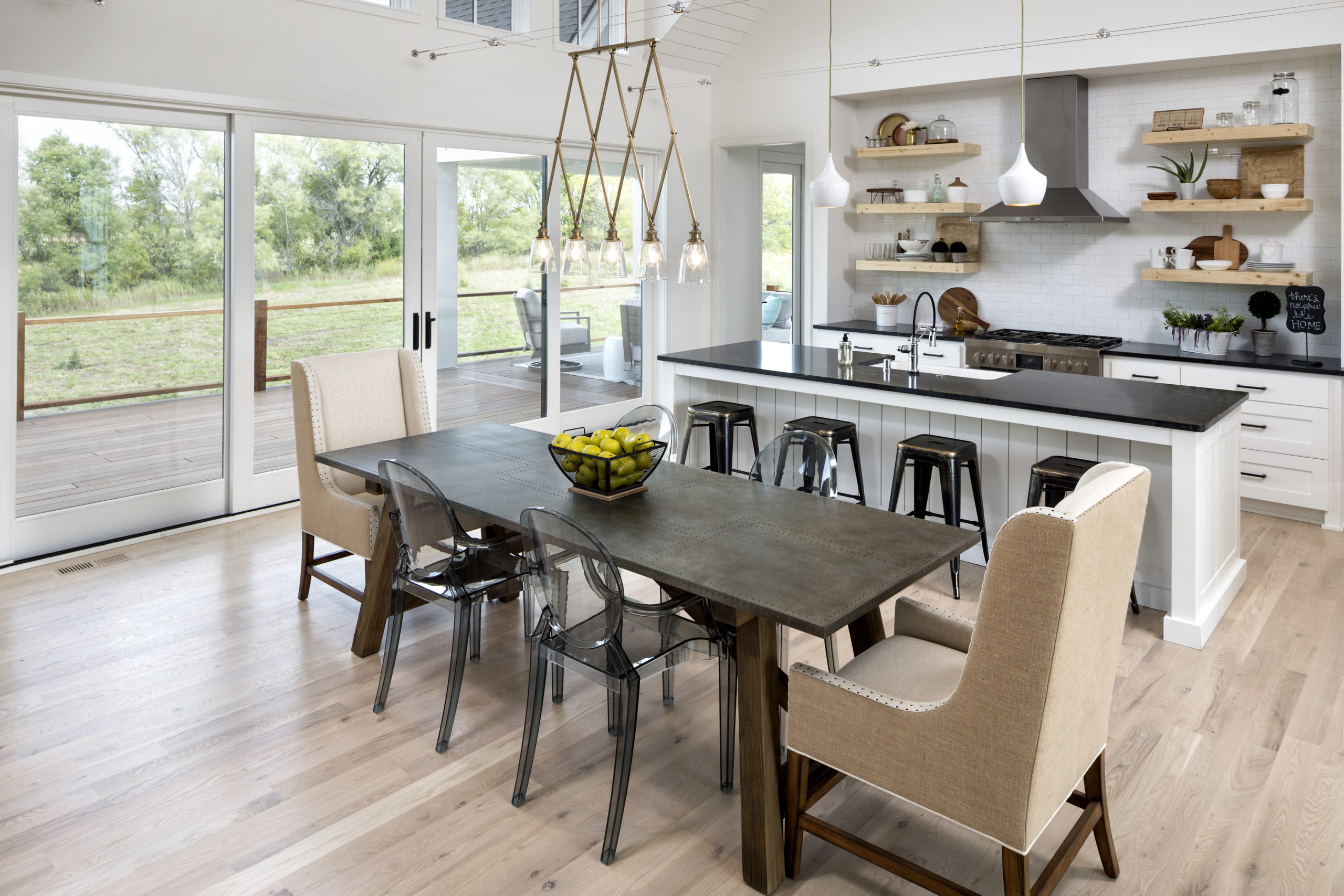 A kitchen with a dining table and chairs.