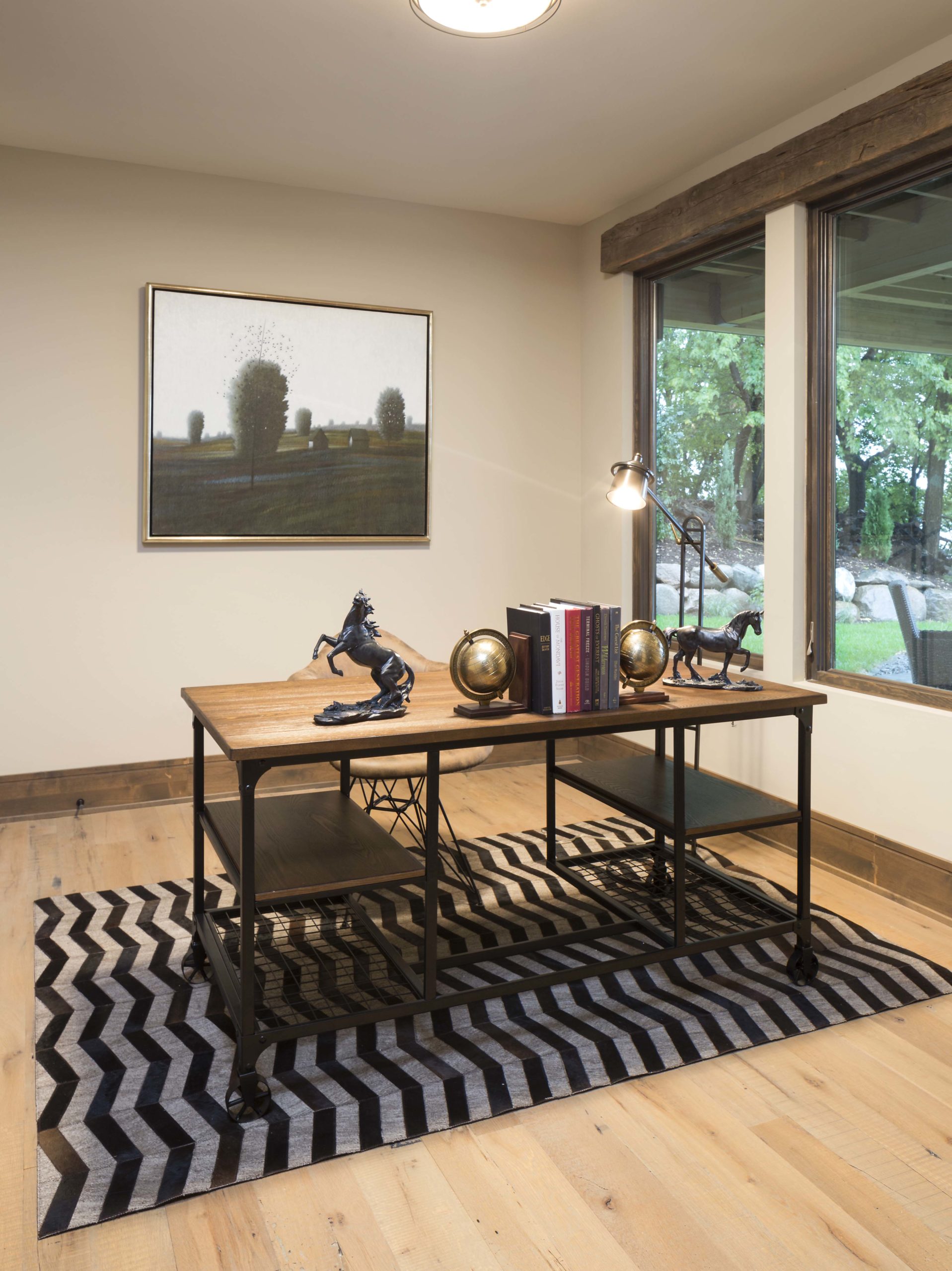 A black and white chevron rug in a home office.