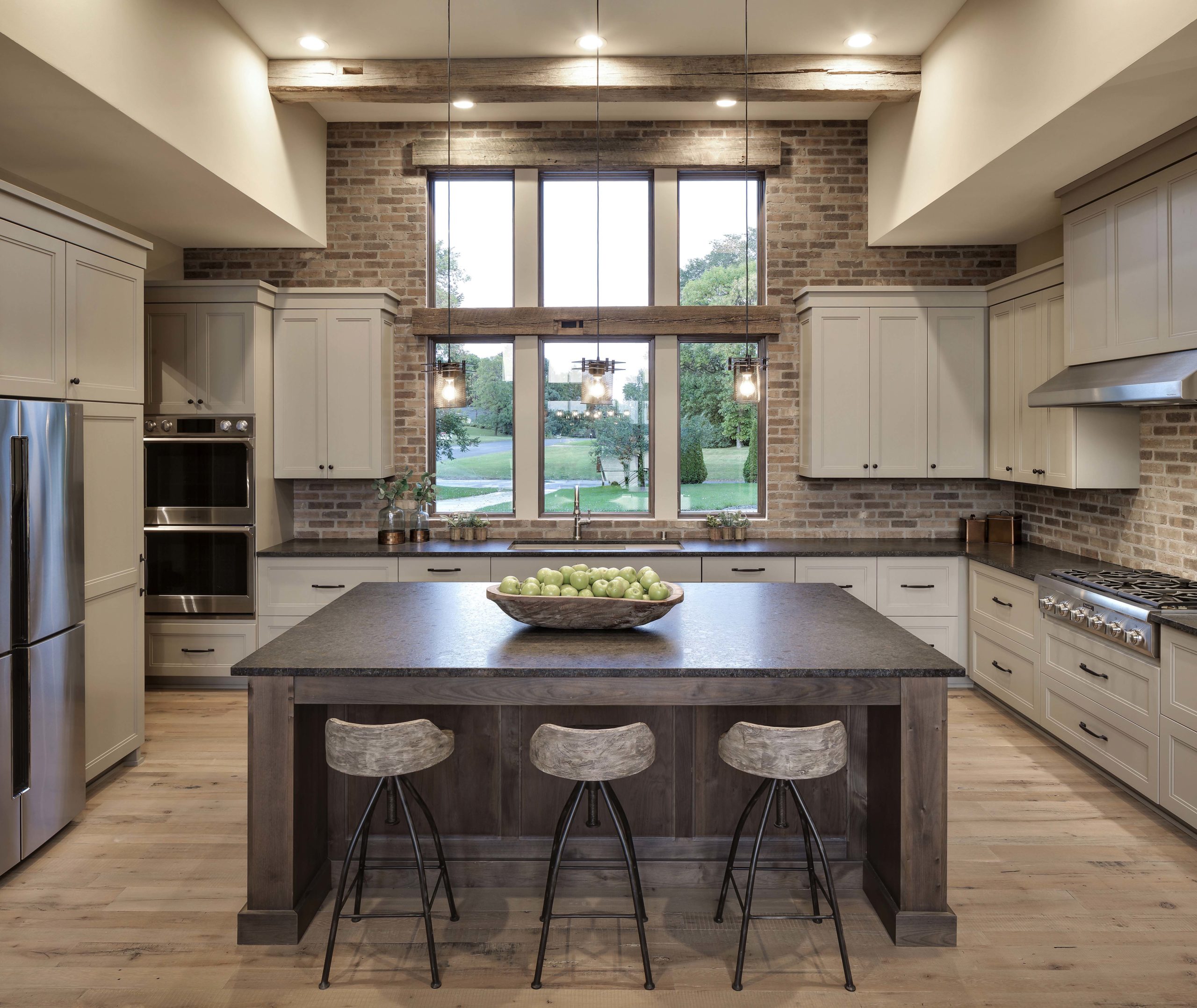 A large kitchen with a center island and stools.