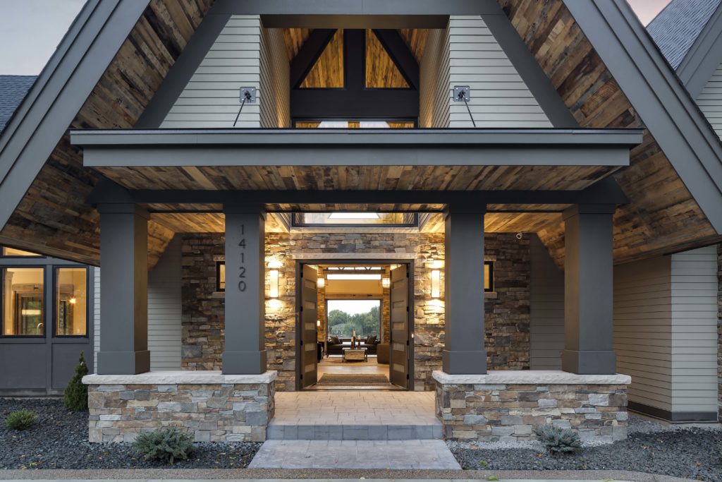 The entrance to a modern home with stone and wood.
