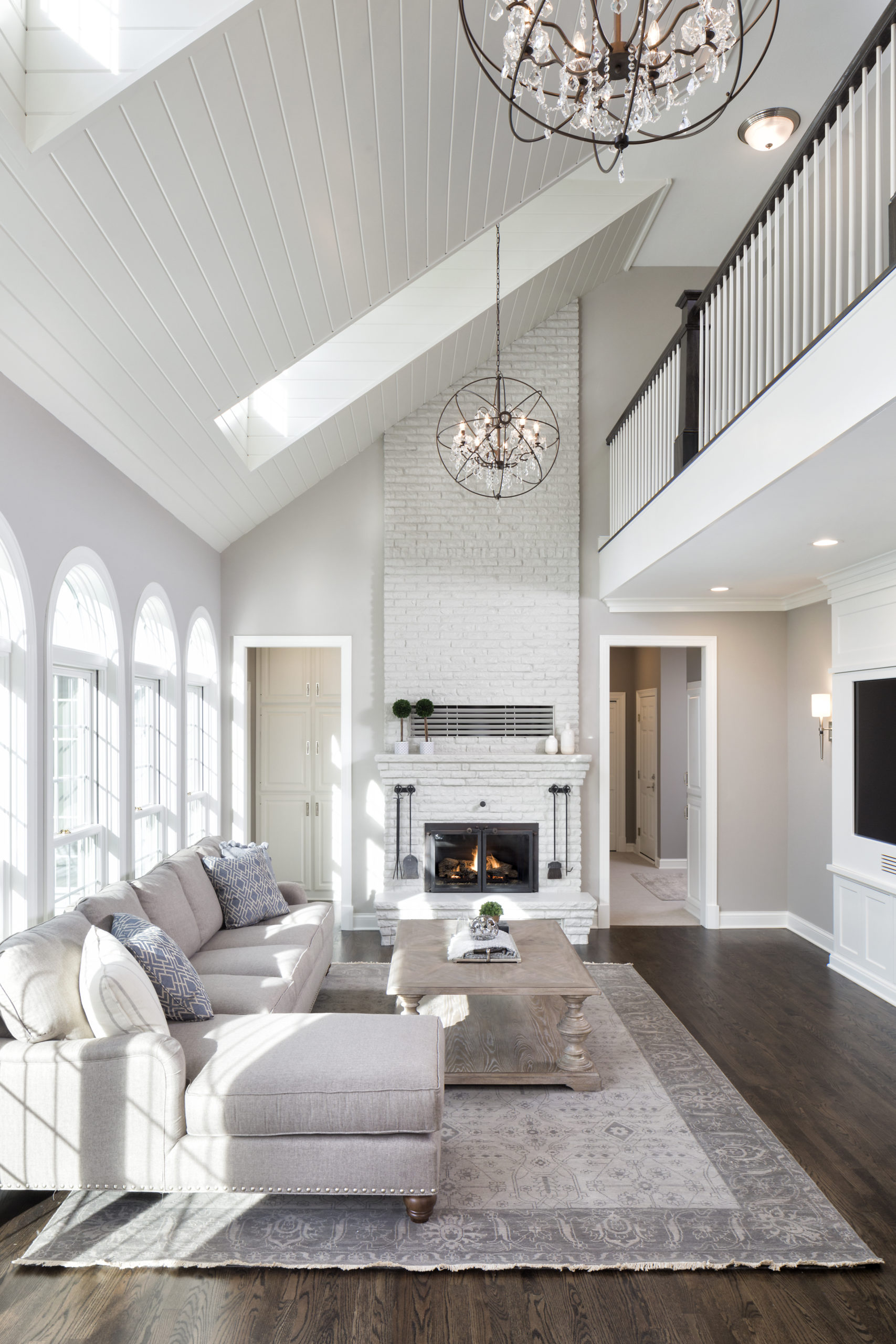 A large living room with hardwood floors and a vaulted ceiling.