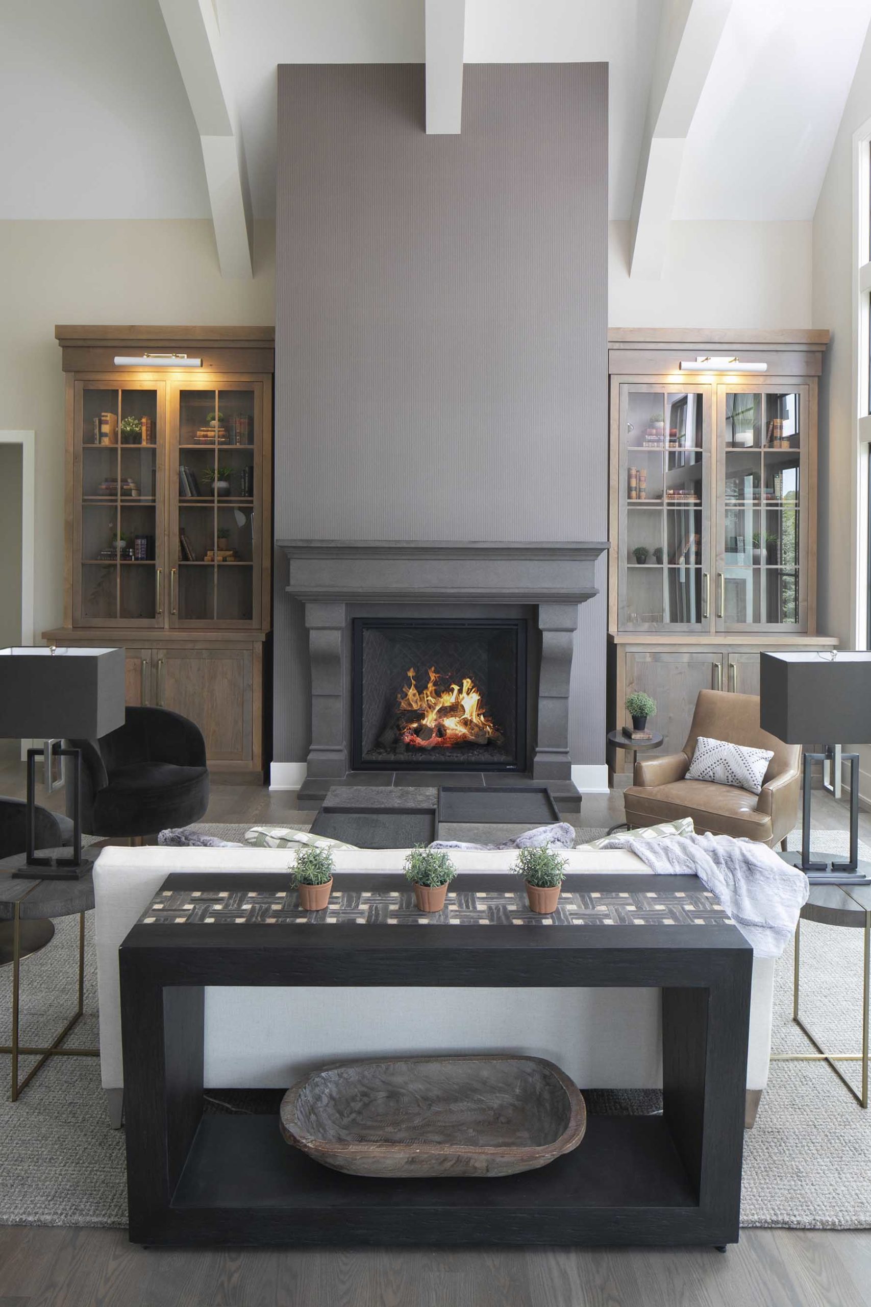 A living room with a fireplace and bookshelves.