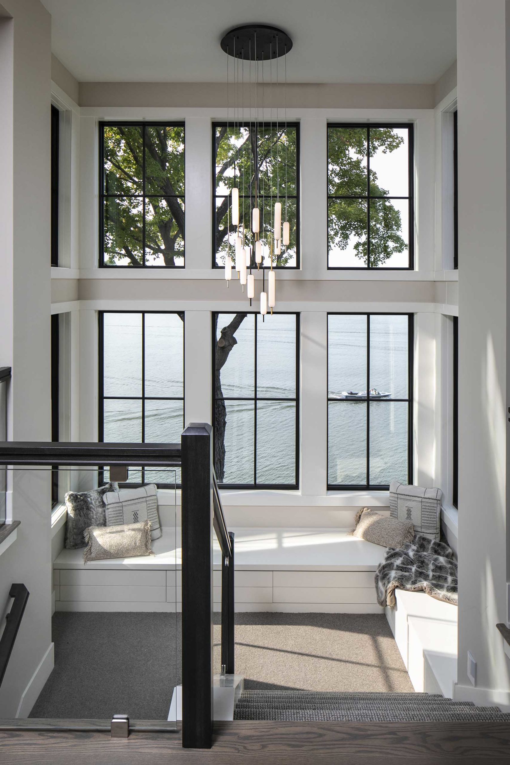 A living room with large windows overlooking the water.