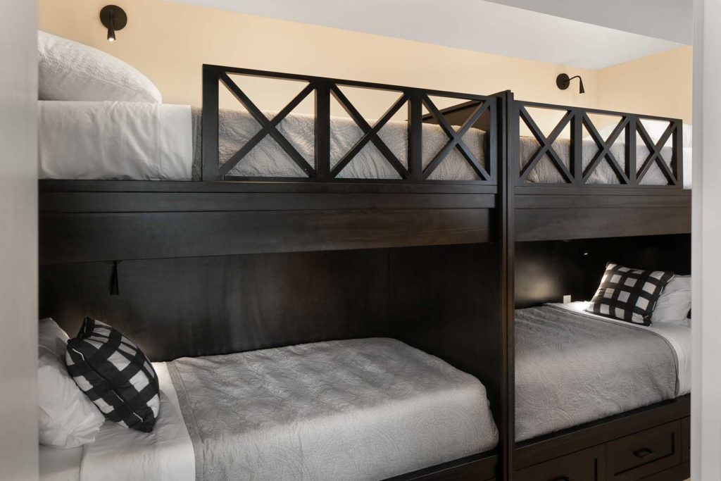 A black and white bunk bed in a bedroom.