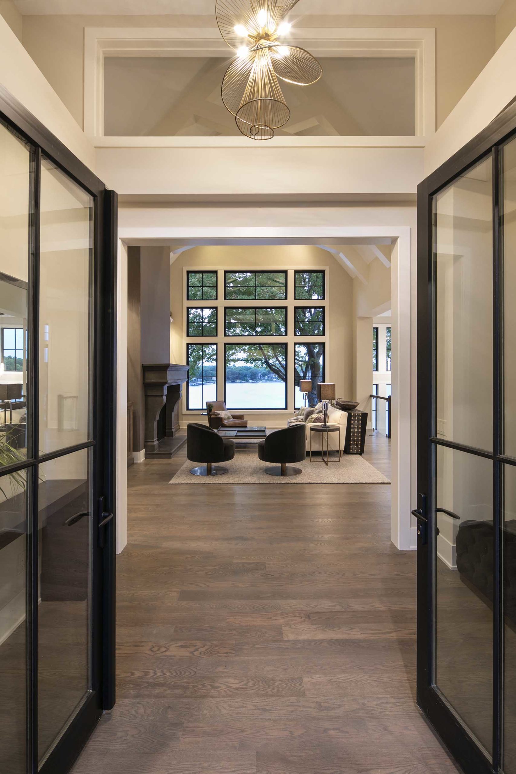 A glass door leads into a large living room.