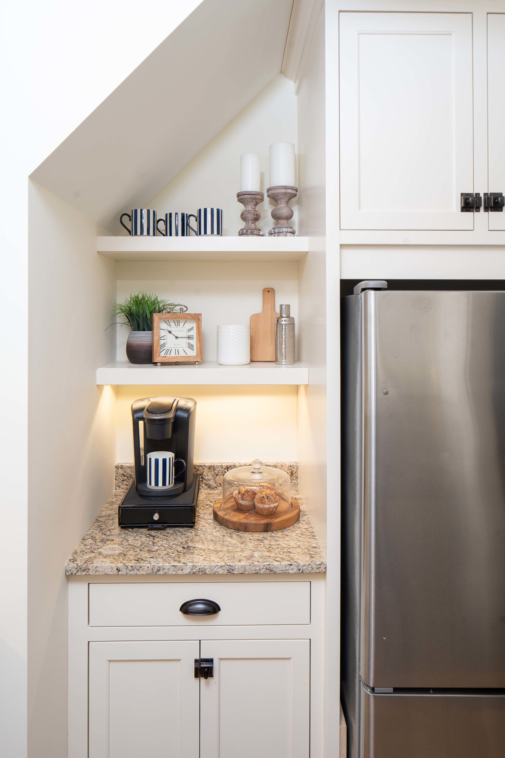 A kitchen with a refrigerator and a coffee maker.