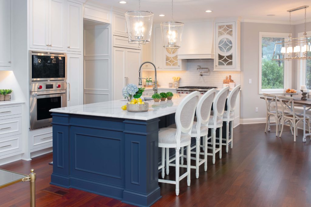 A white kitchen with a blue island.