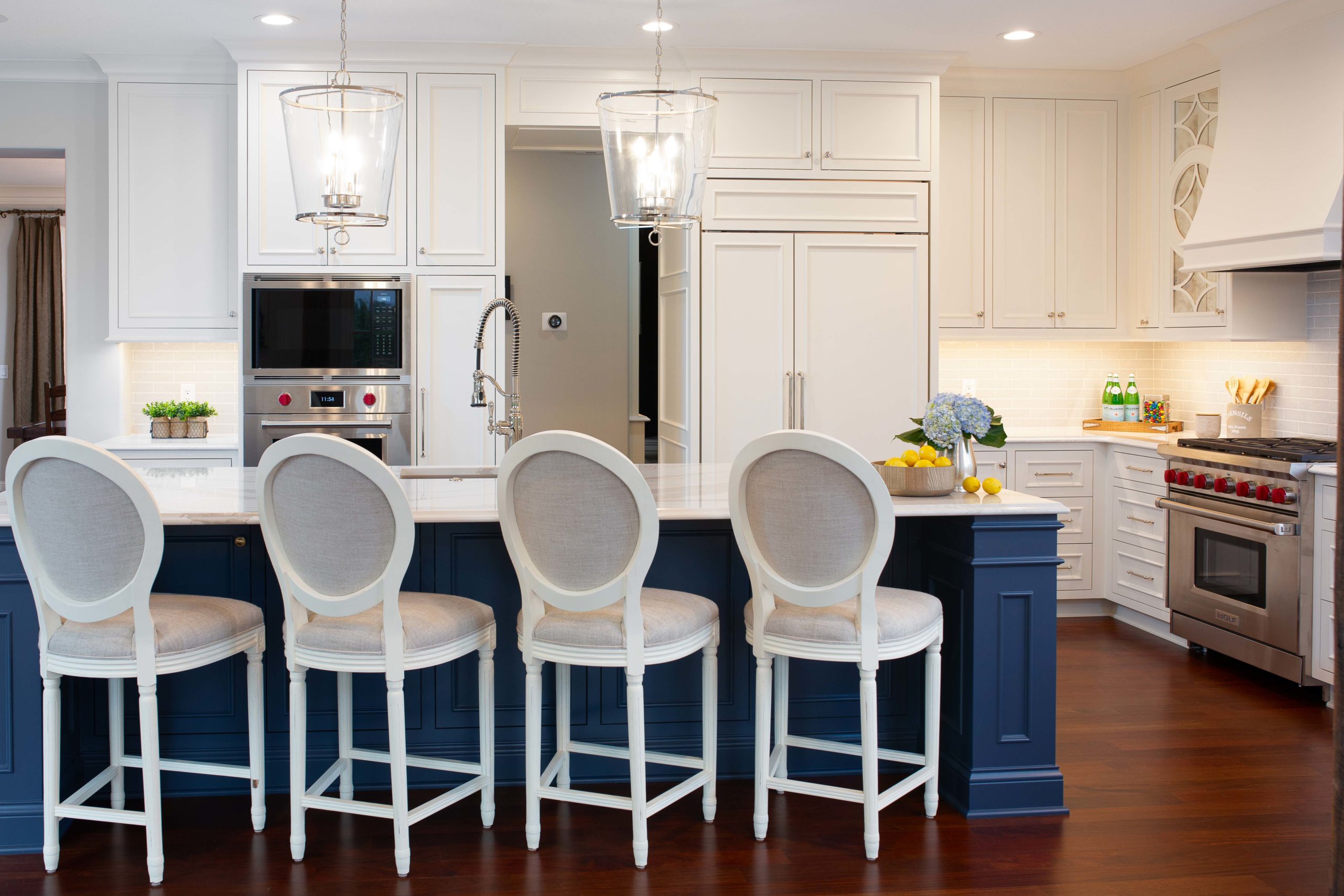A kitchen with white cabinets and blue counter tops.