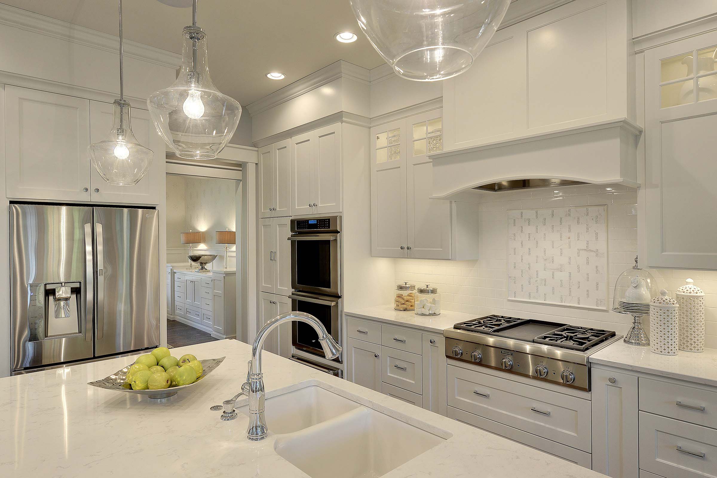 A white kitchen with a sink.