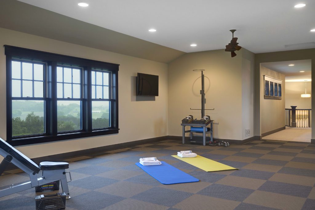 A room with a gym equipment and a window.