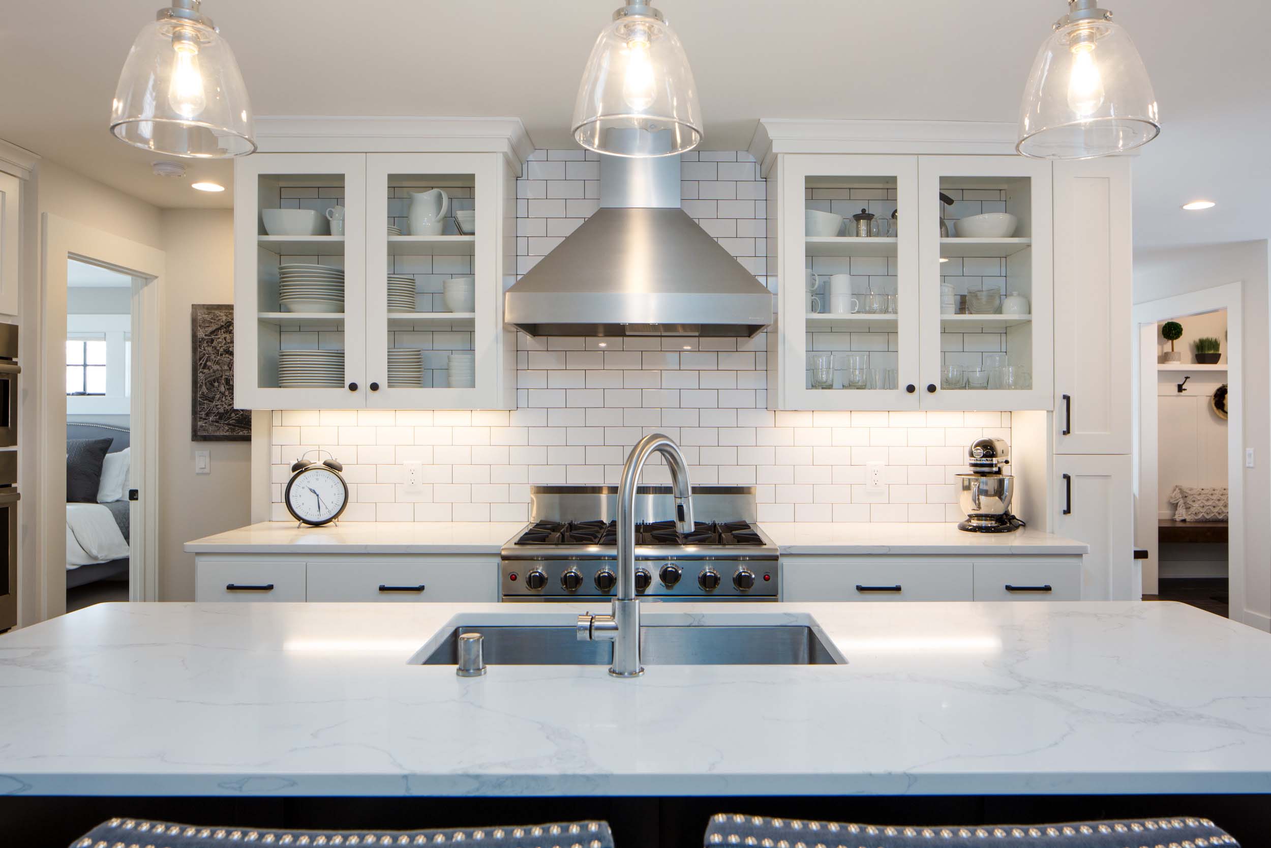 A kitchen with a white counter top and stainless steel appliances.