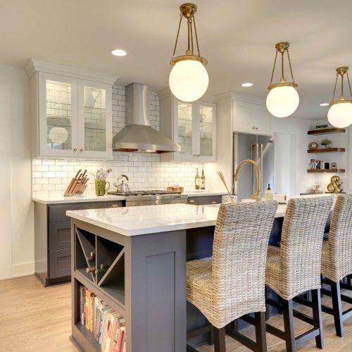 A kitchen with a center island and stools.