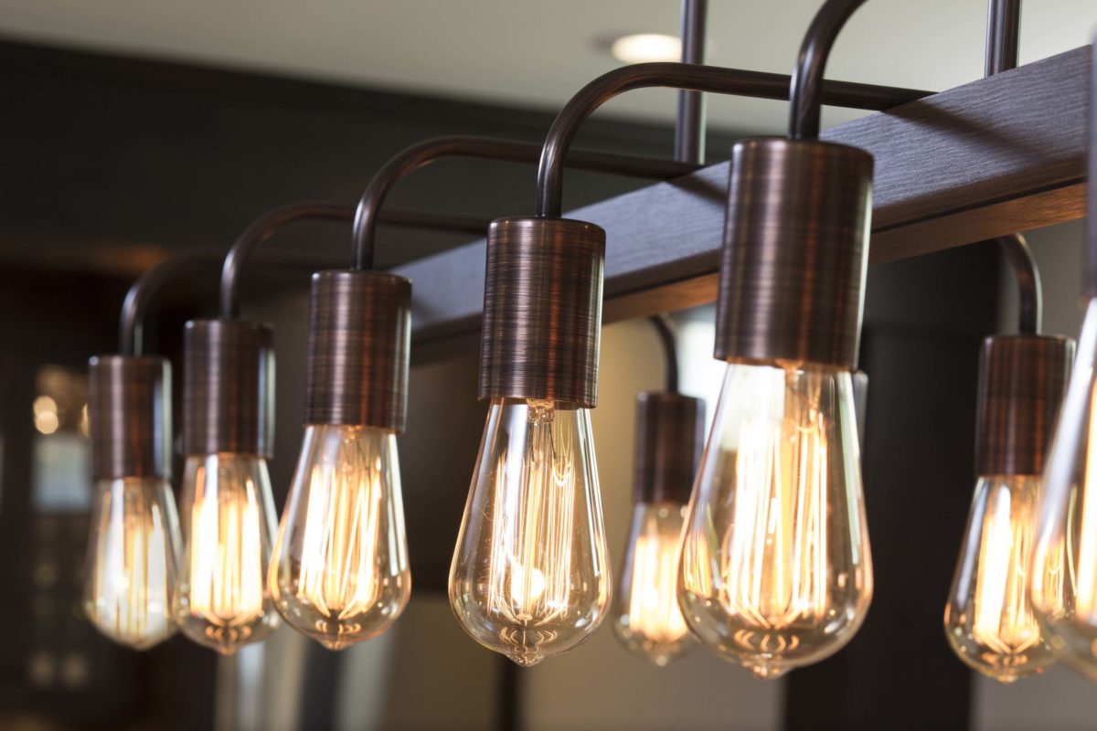 A row of light bulbs hanging from a metal fixture in an Edina remodel project.
