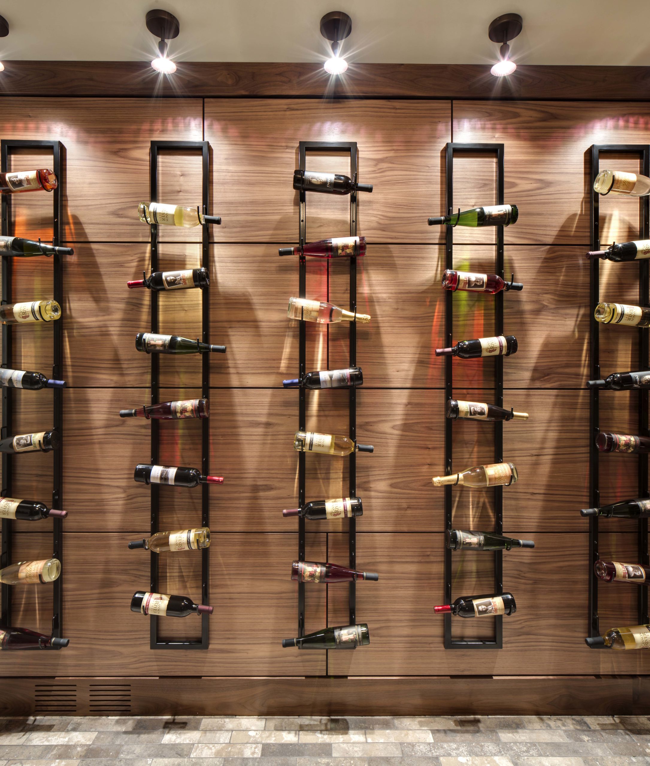 A wall of wine racks in a room.