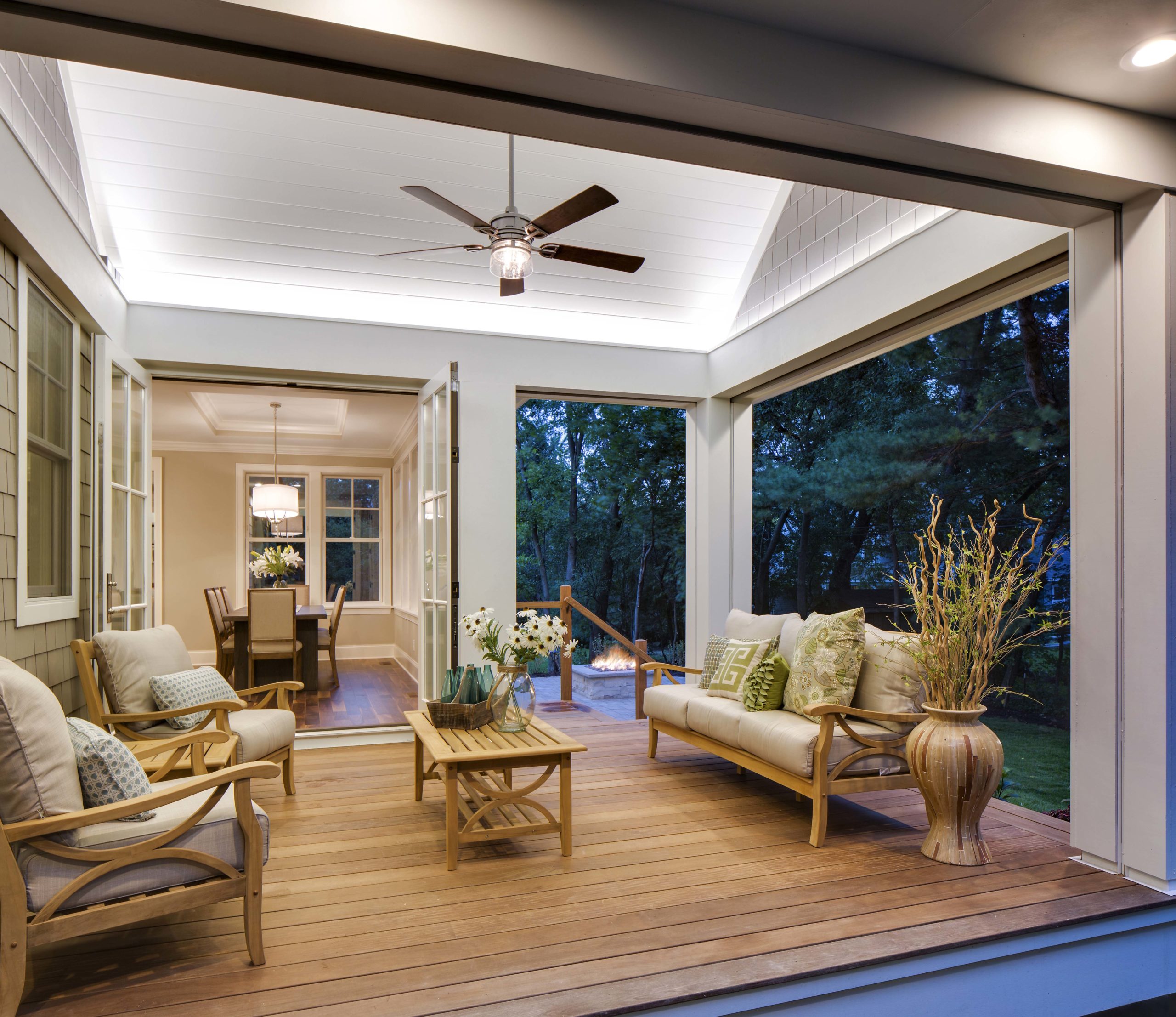 A porch with furniture and a ceiling fan.