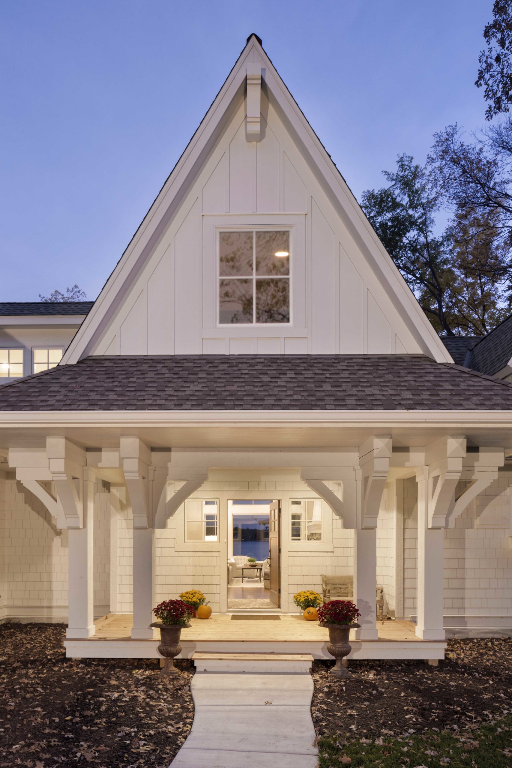 A white home with a white porch and white siding.