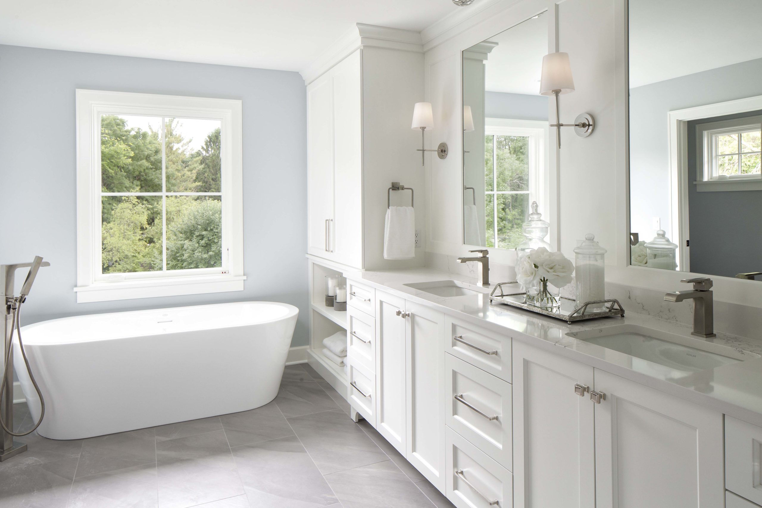 A white bathroom with a tub and sink.