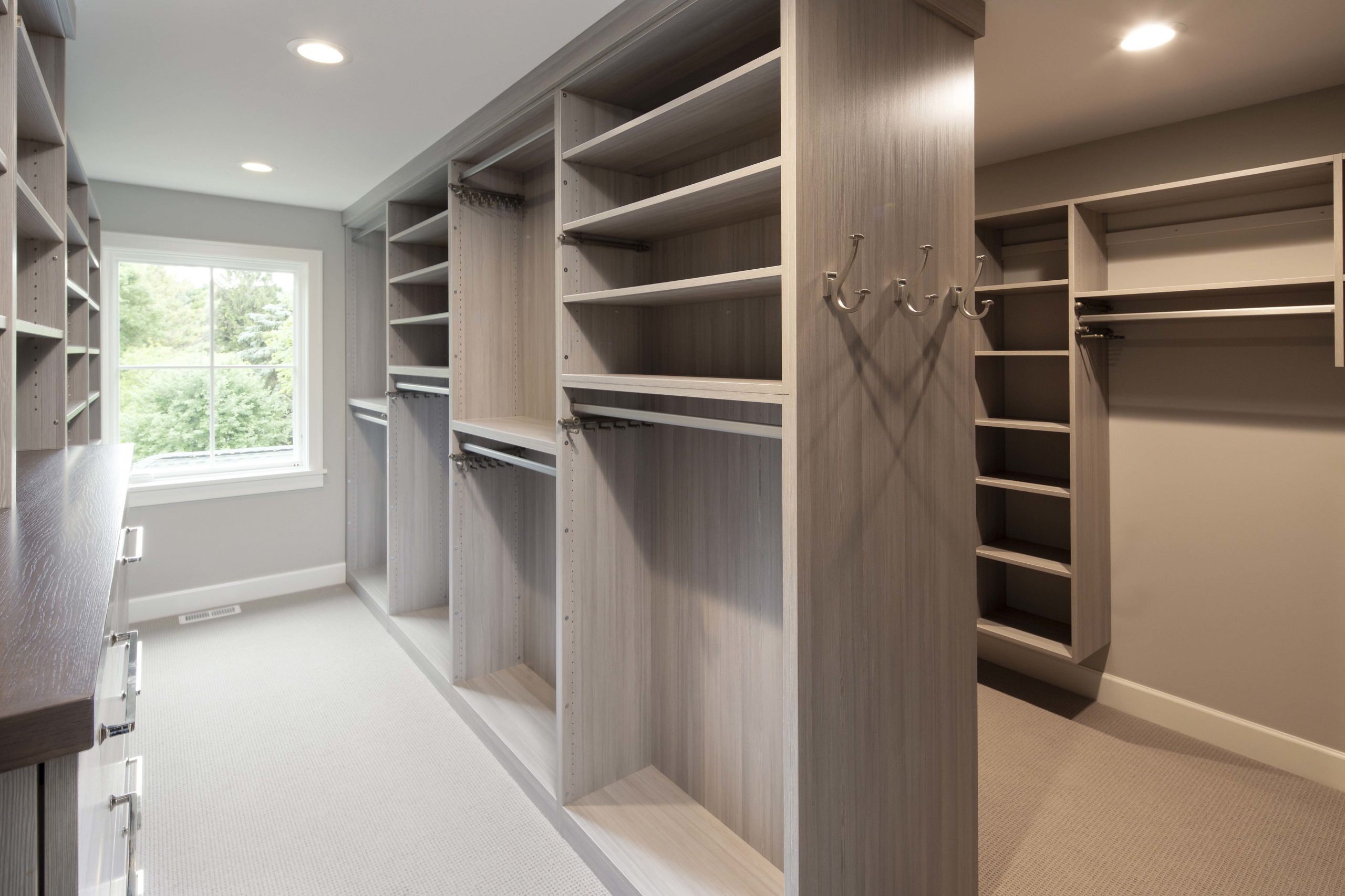 A walk in closet with shelves and drawers.