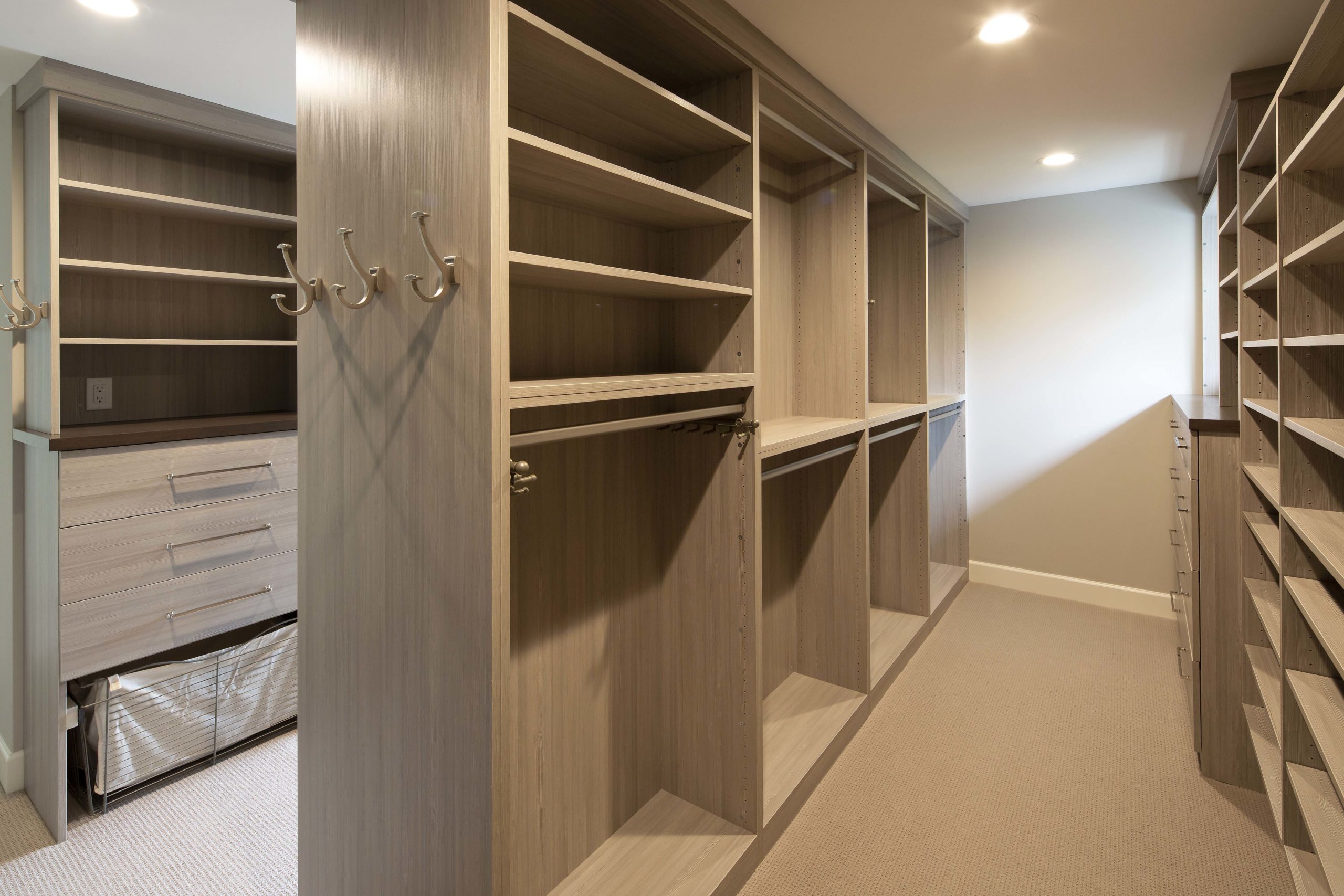 A walk in closet with shelves and drawers.