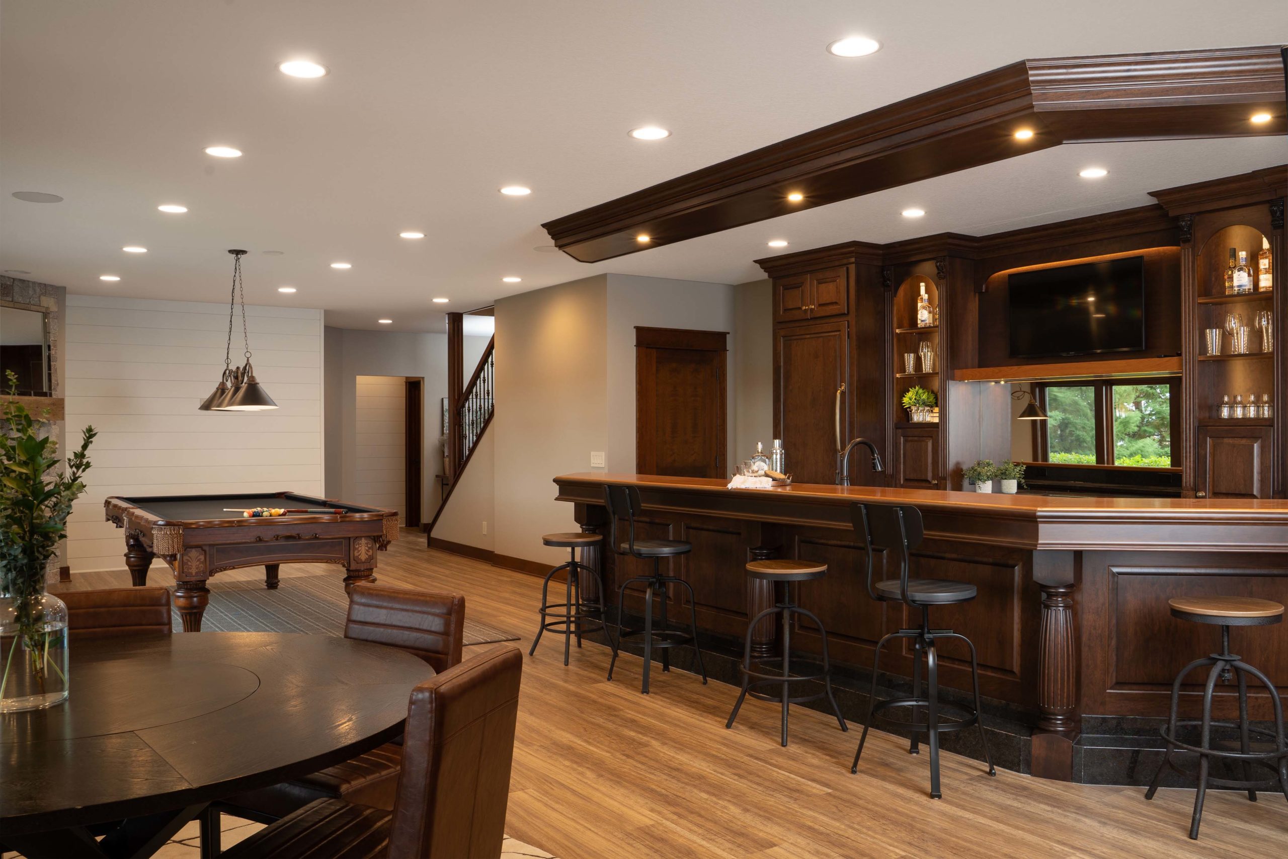 A home bar with a pool table and billiard table.