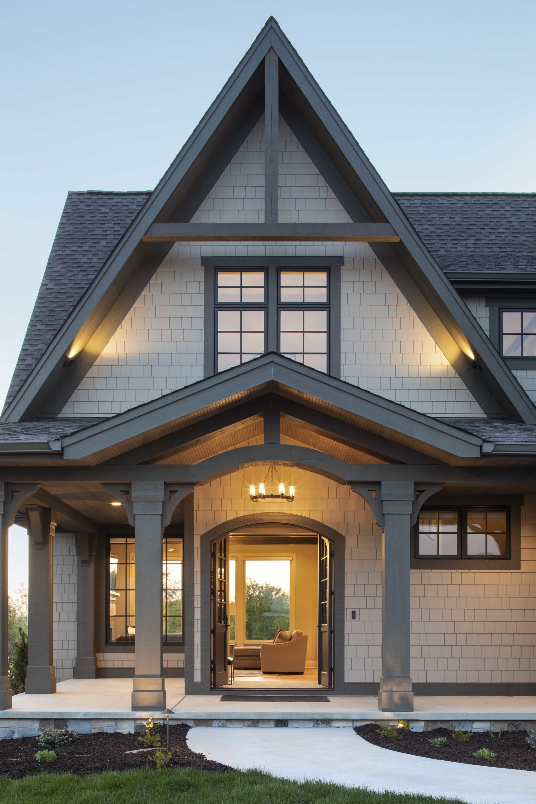 A home with a large front porch and a large front door.