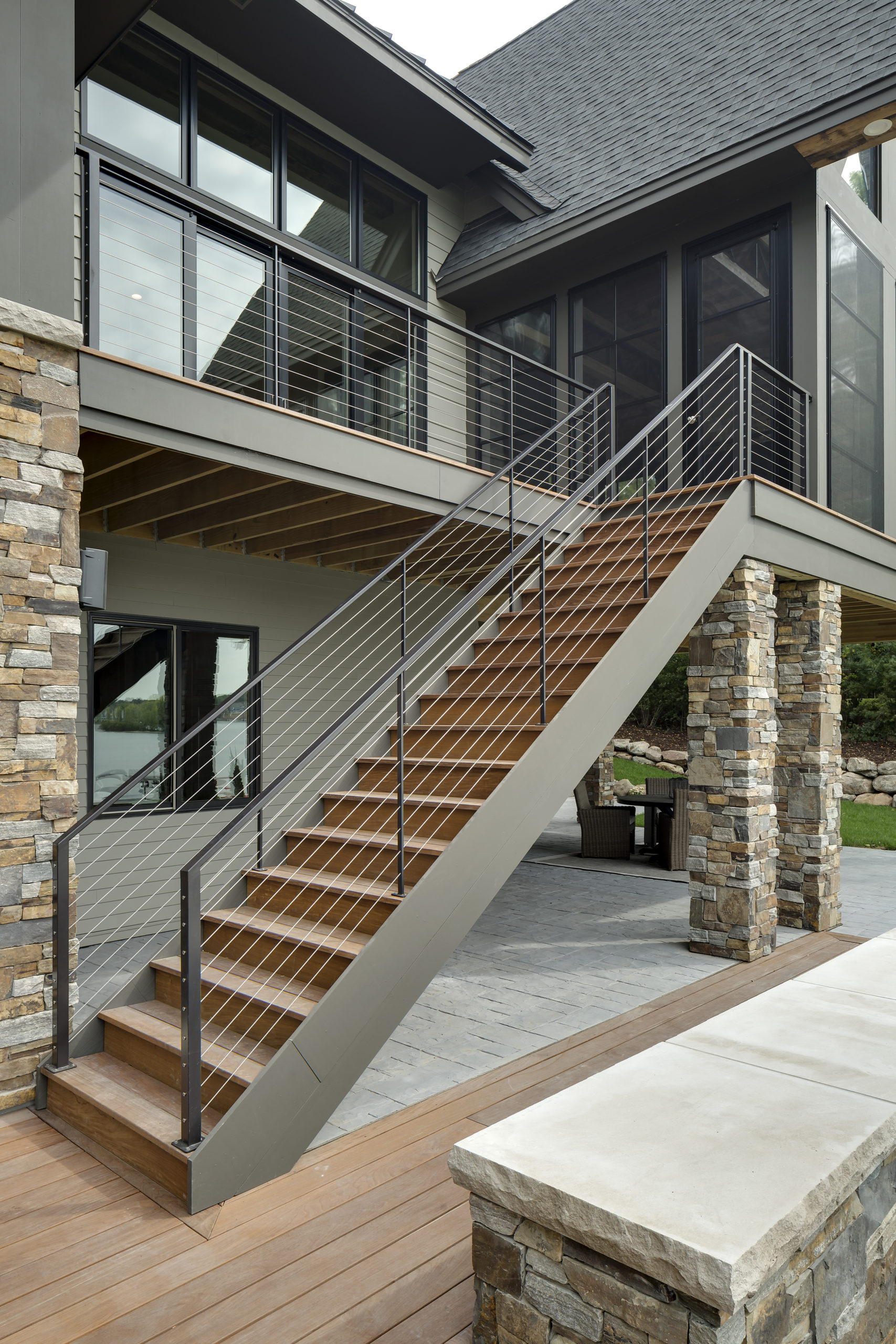 A house with stairs leading up to a deck.
