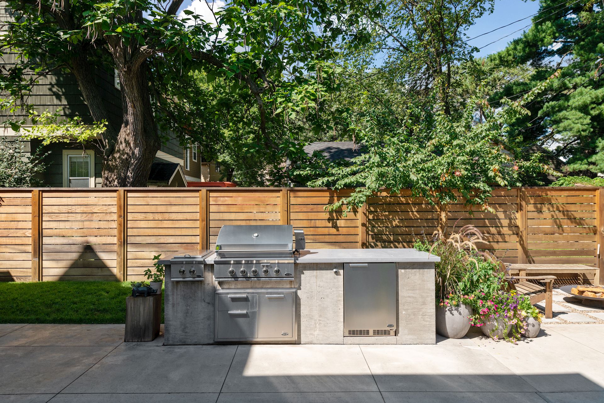 A concrete patio with a grill.