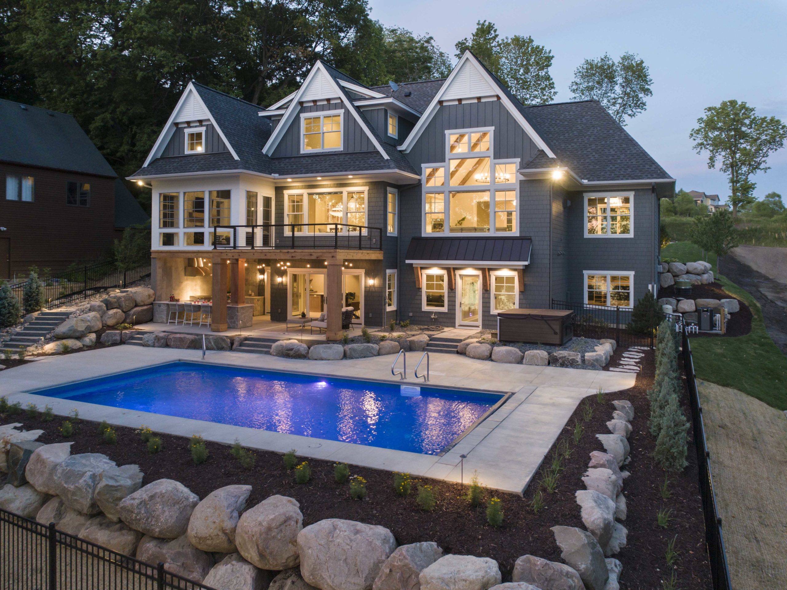 A custom lake home build with a swimming pool and landscaping.