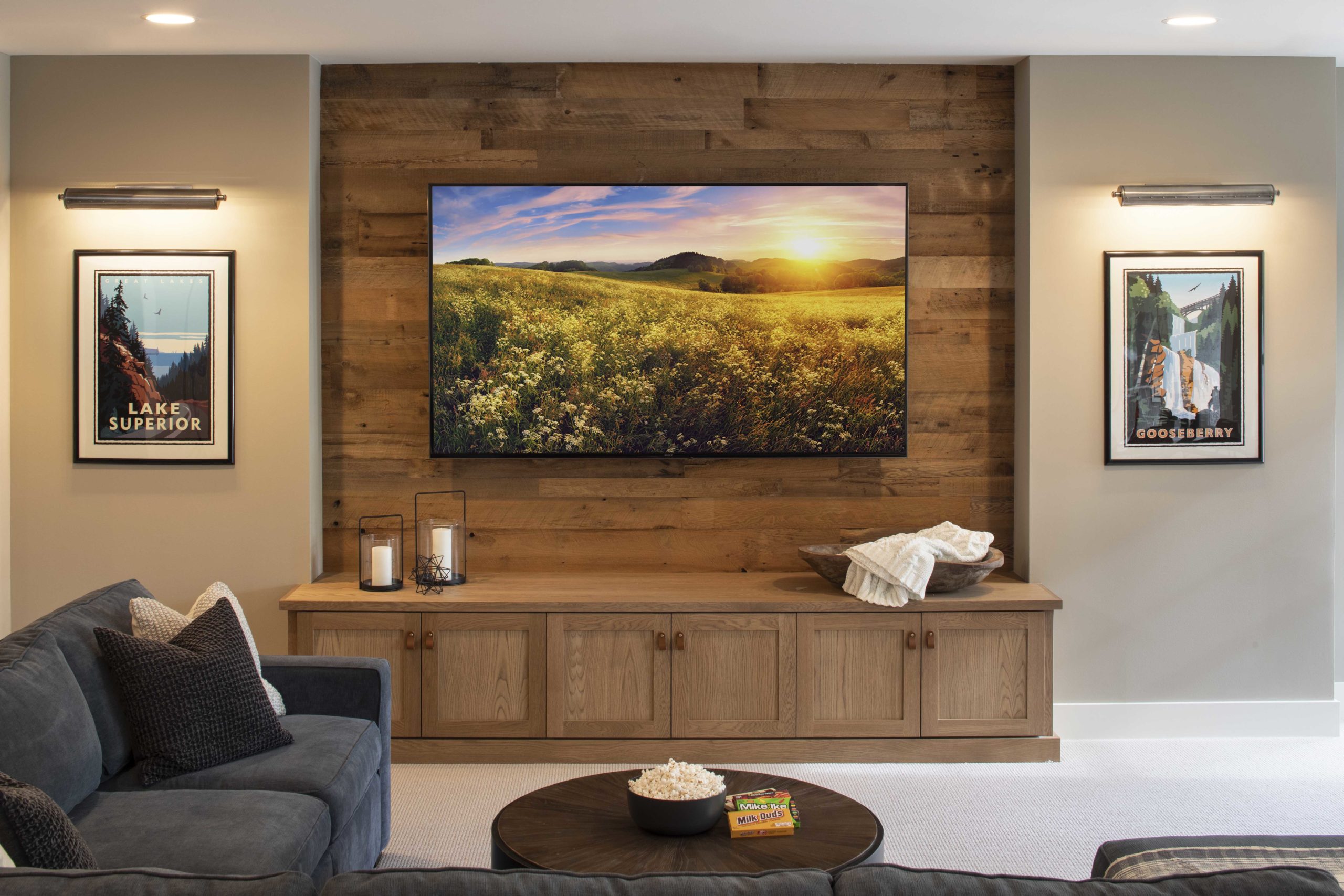 A custom lake home living room with a tv mounted on the wall.