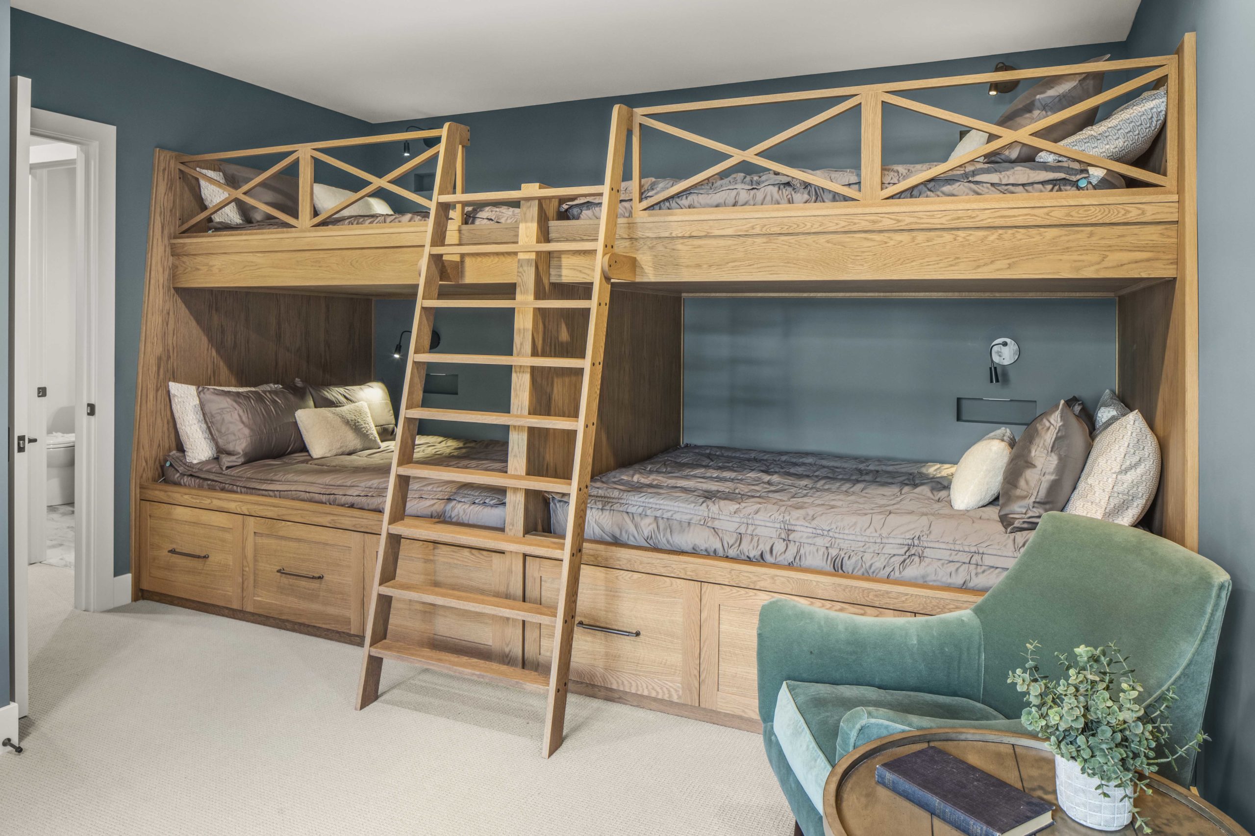 A custom lake home build featuring a bunk bed in a room with blue walls.