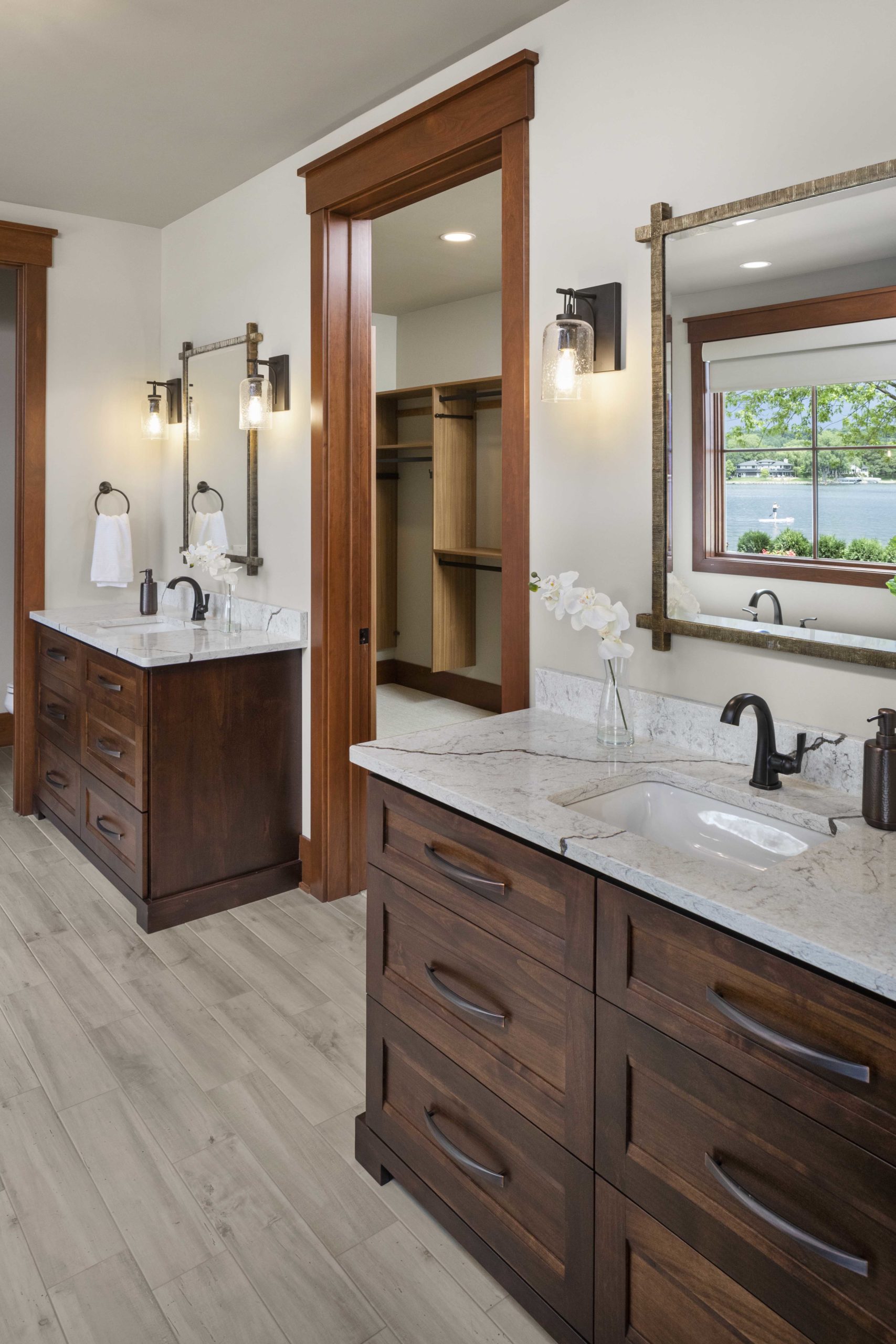 A custom home remodel featuring a bathroom with two sinks and a large mirror.