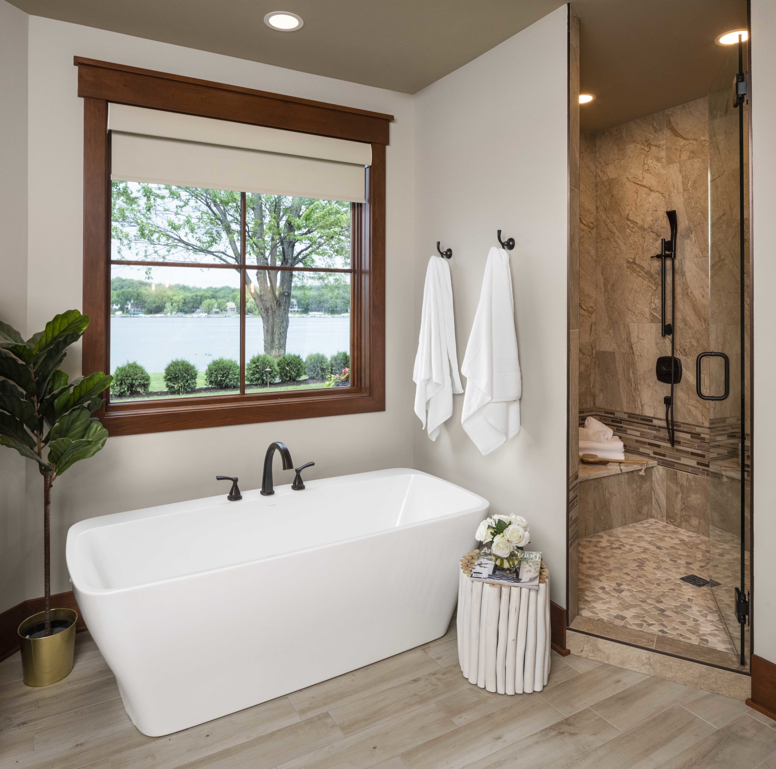 A custom home remodel featuring a bathroom with a large tub and a window.