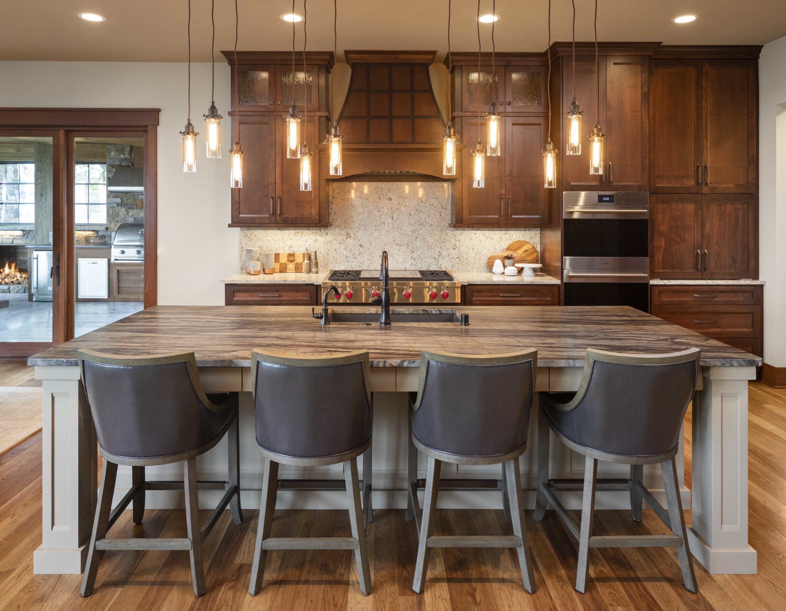 A custom home remodel featuring a kitchen with a center island and bar stools.