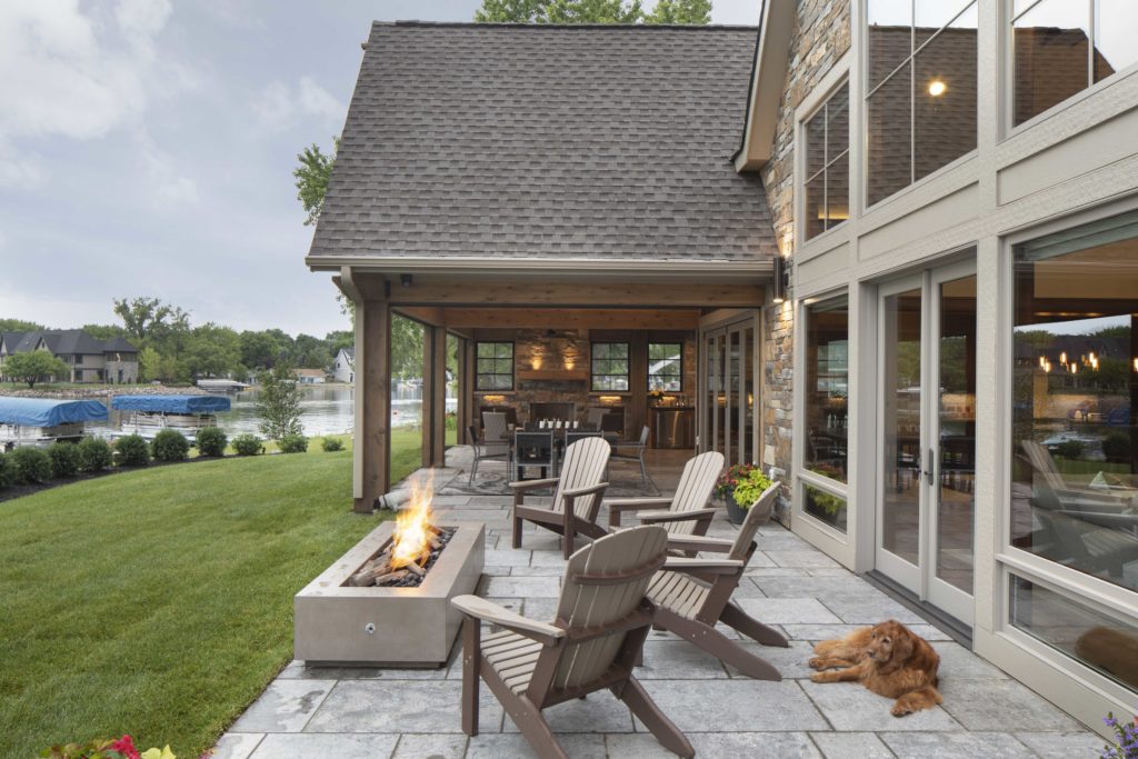 A custom-built patio with chairs and a fire pit.