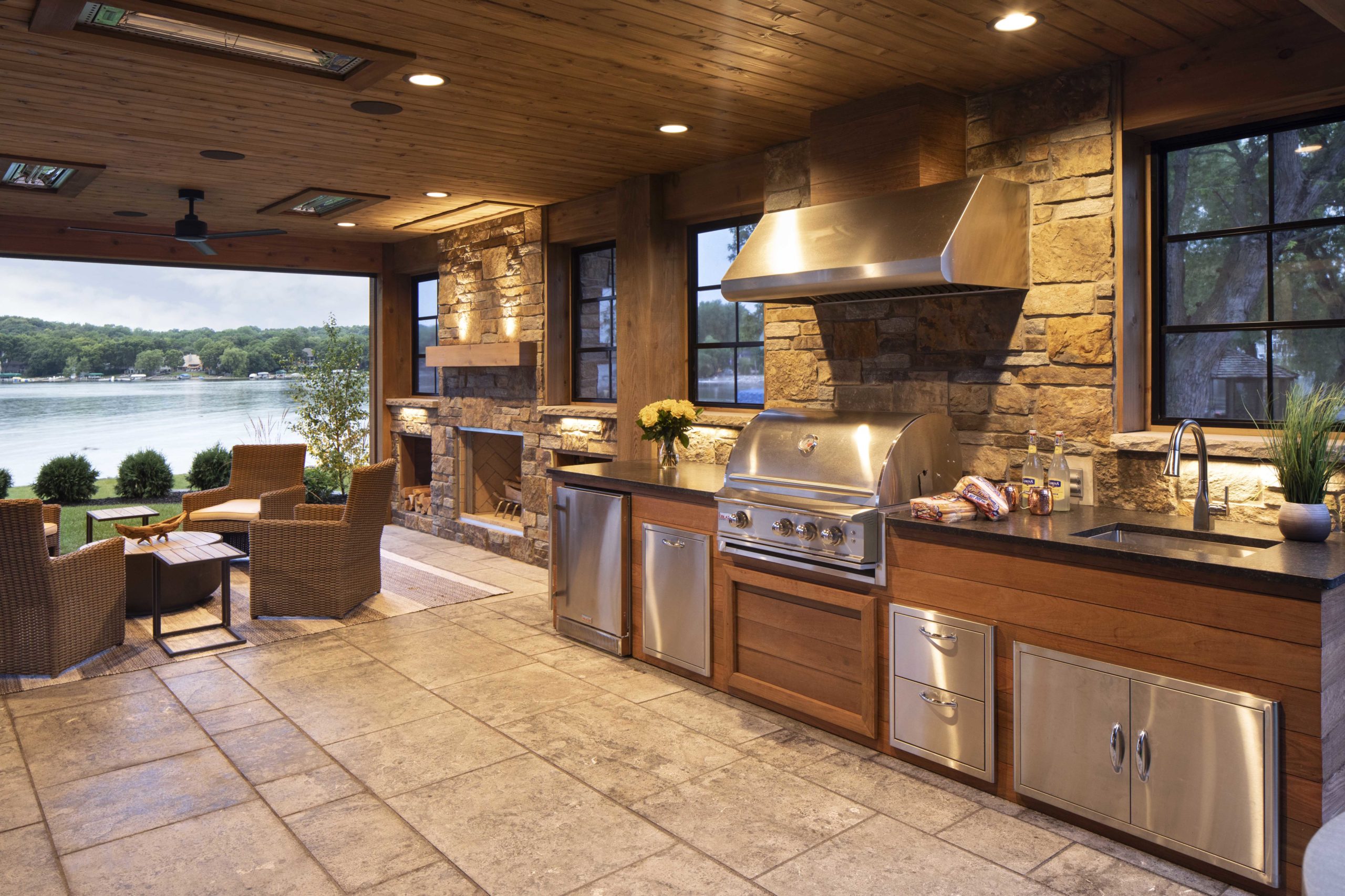 Custom home remodel: An outdoor kitchen featuring a grill and fireplace.