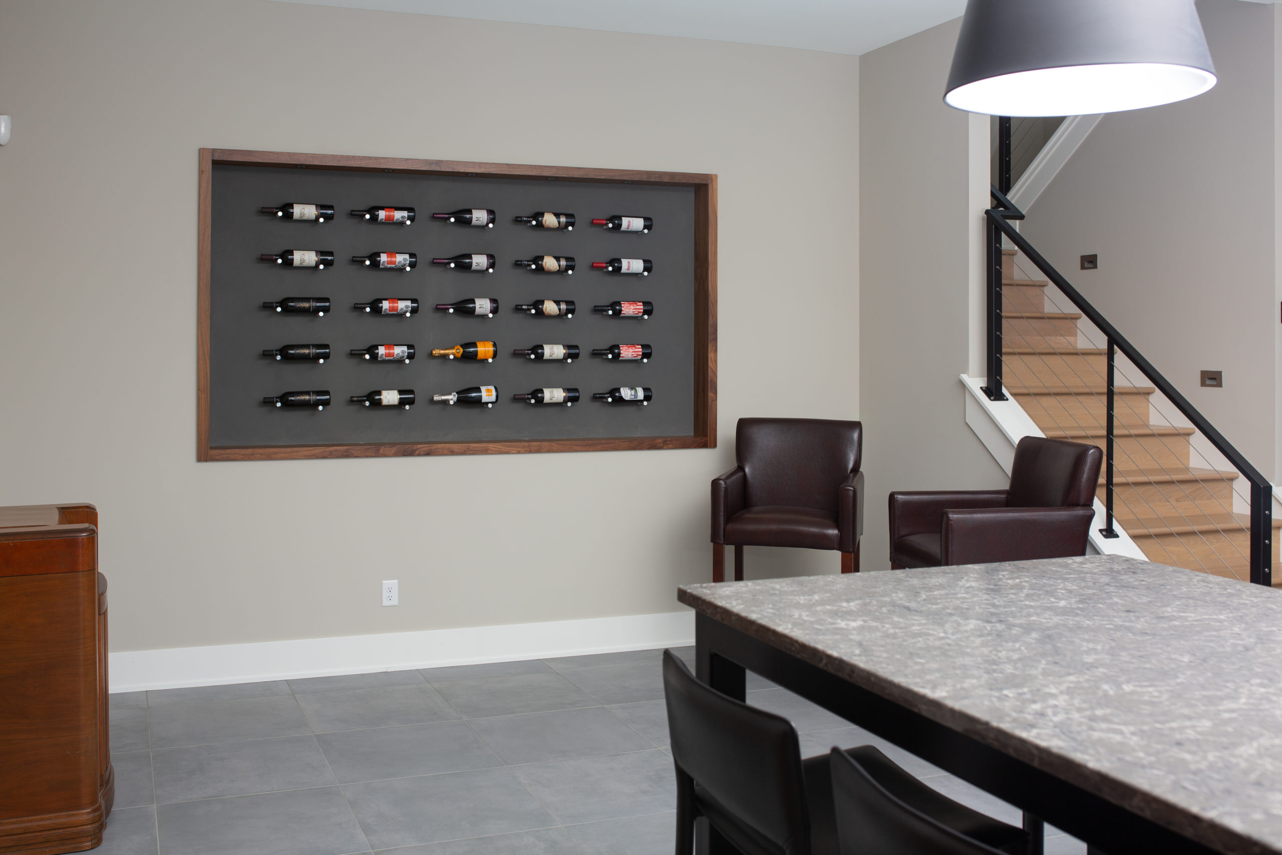 A modern lake home build featuring a stunning wall of wine bottles.