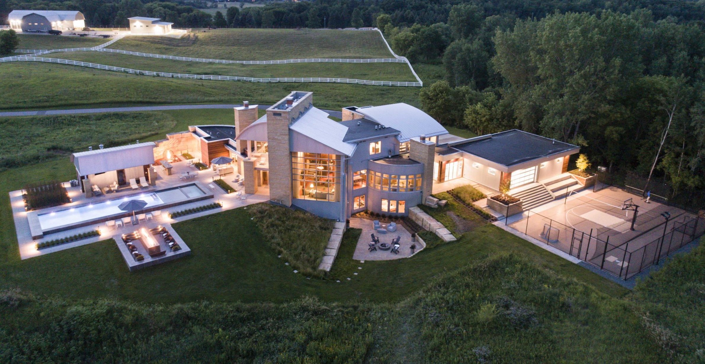 A contemporary farmhouse nestled in the countryside, captured beautifully from an aerial perspective.