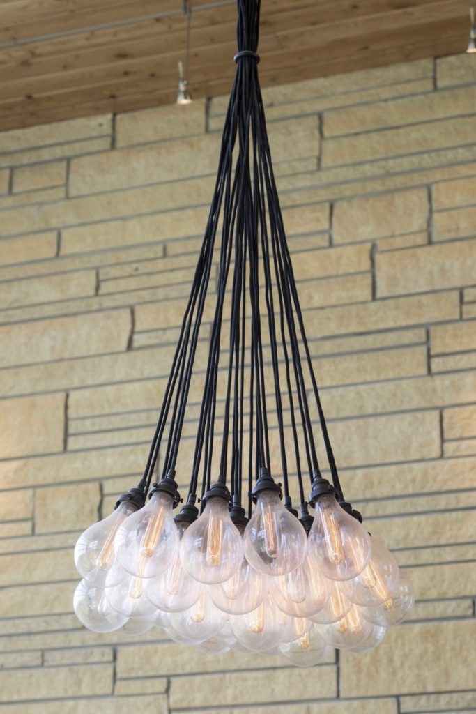 A contemporary chandelier with a lot of bulbs hanging from it.
