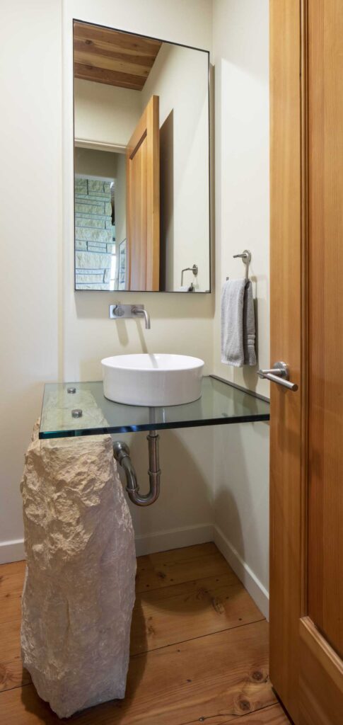 A contemporary bathroom with a sink and a mirror.